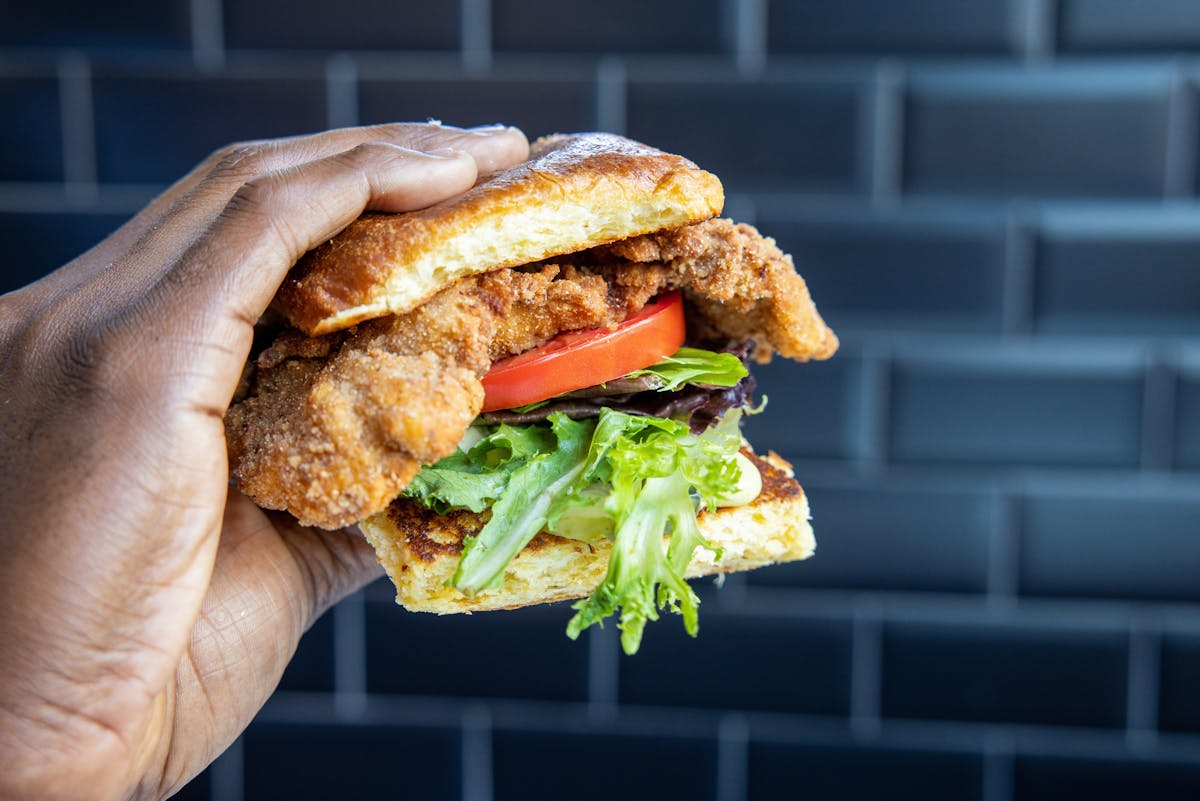 a close up of a hand holding a sandwich