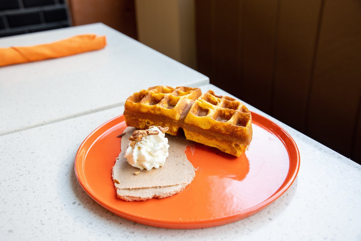 a plate of food with a slice of orange