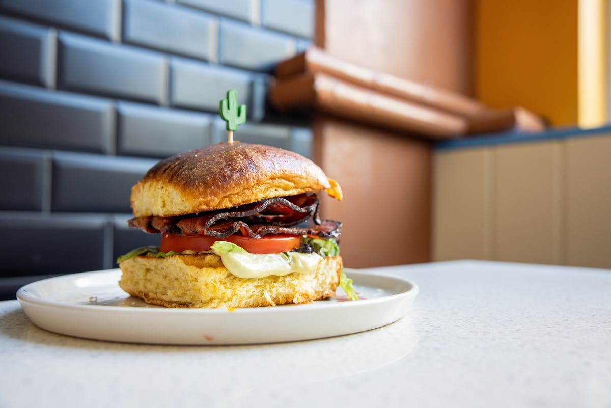 a sandwich sitting on top of a plate of food on a table