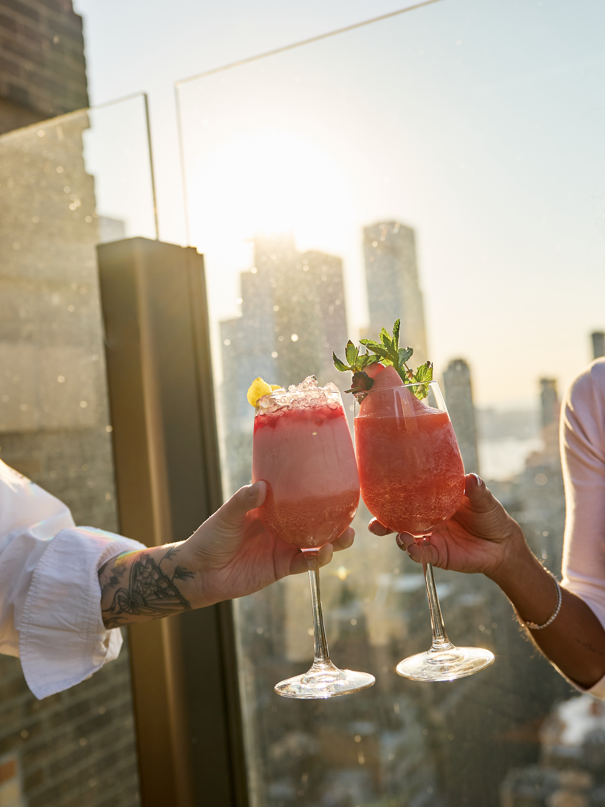 two people holding drinks in their hands
