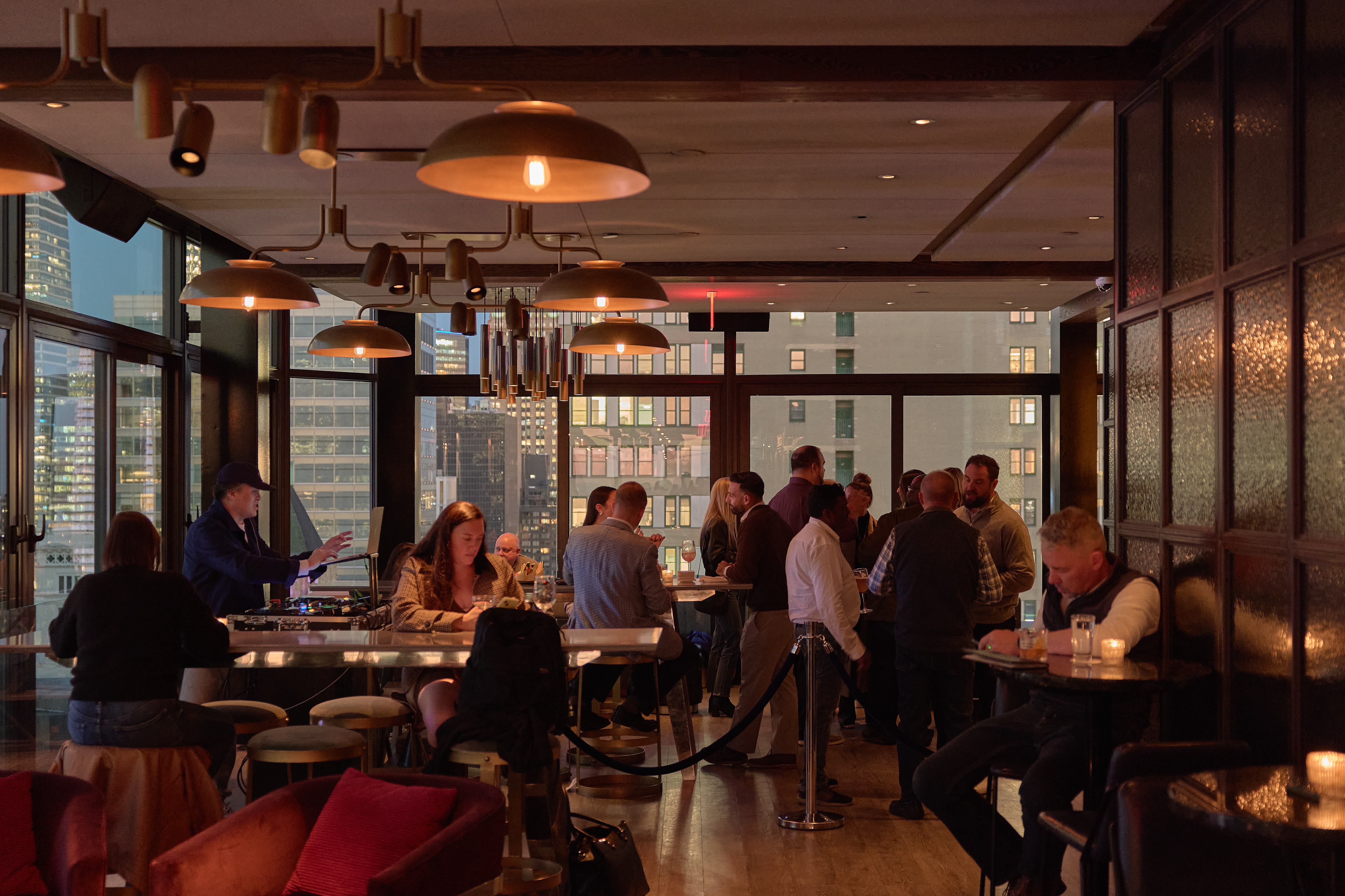 a group of people sitting at tables in a restaurant