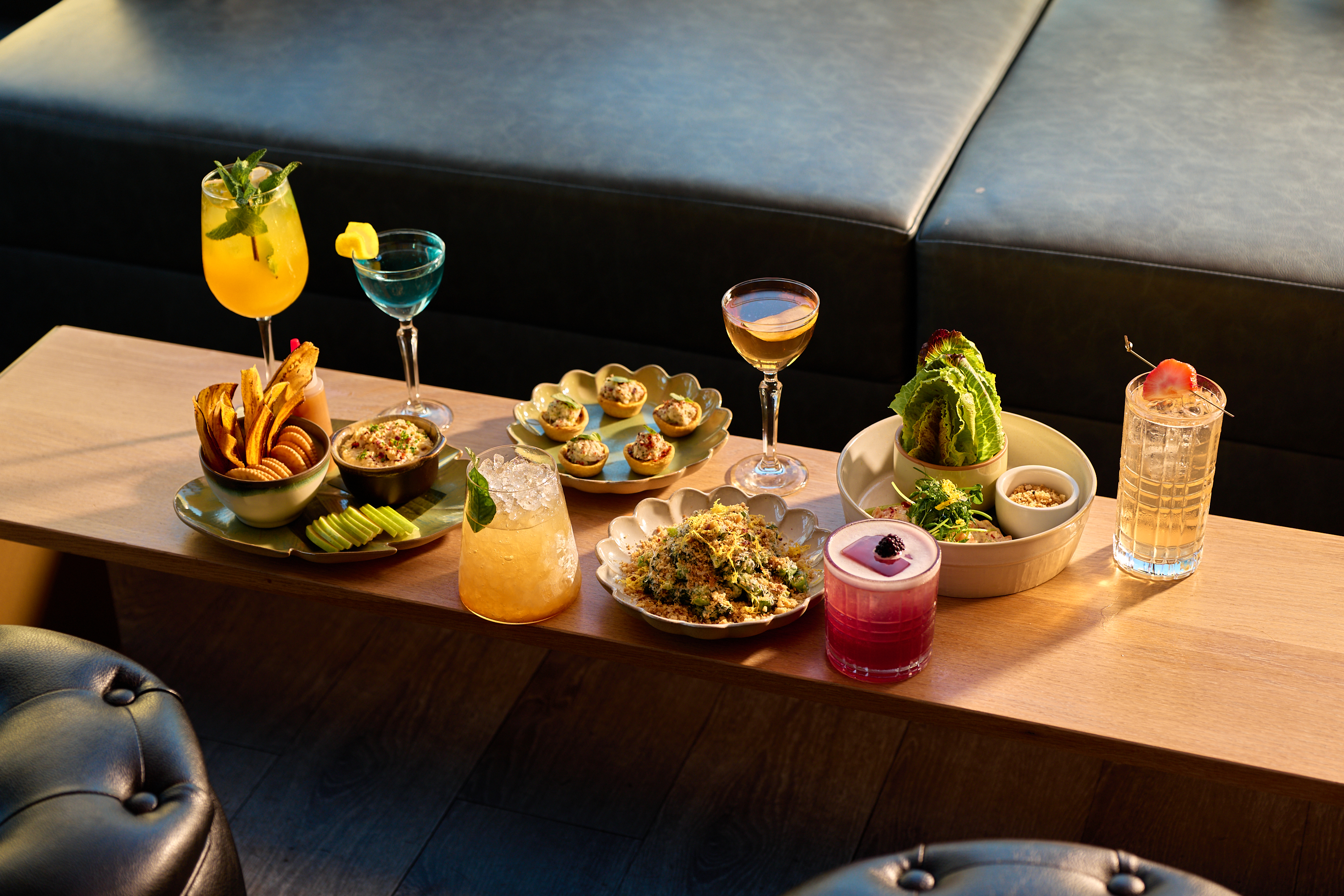 a table with cocktails and food
