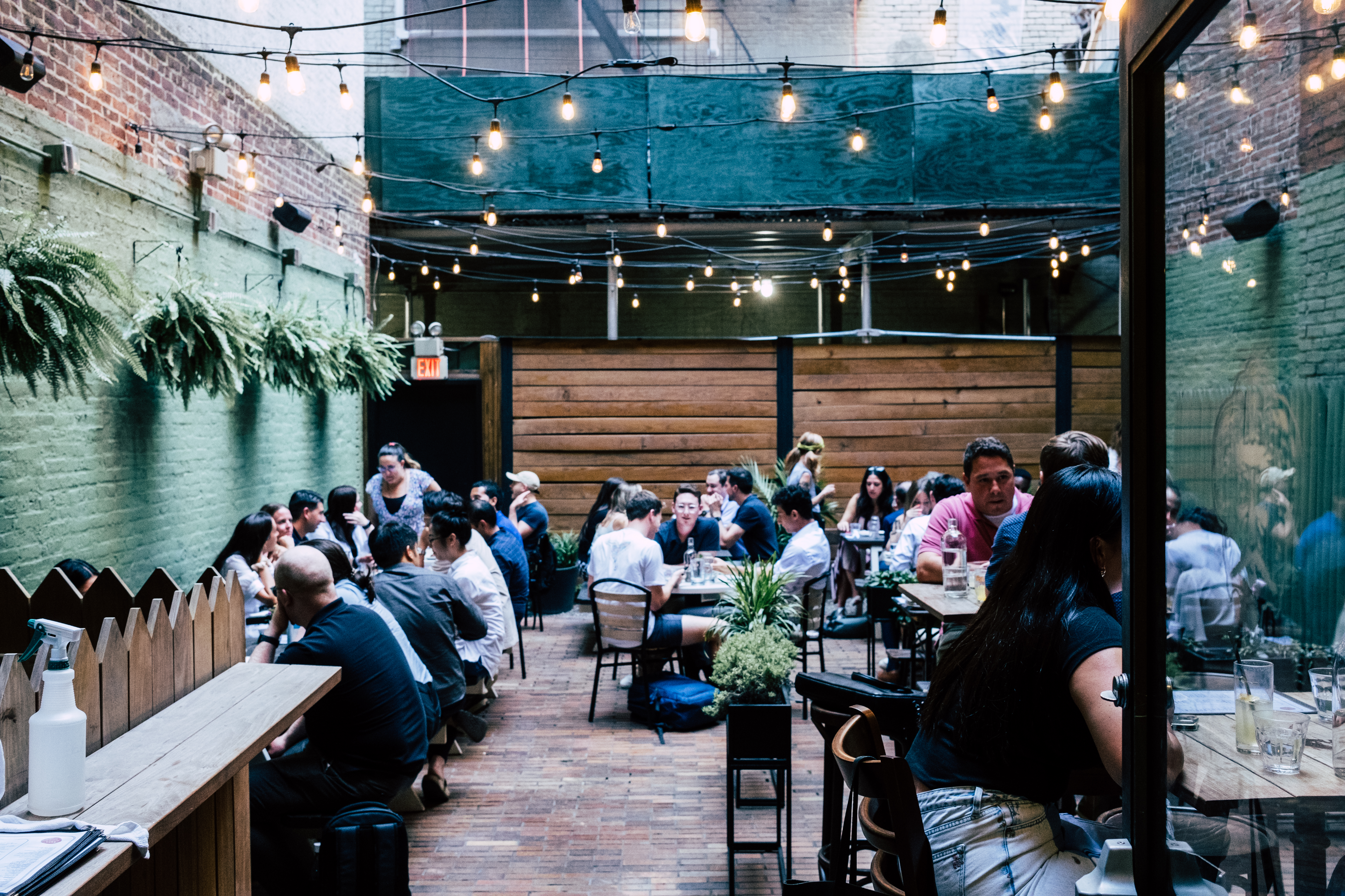 a group of people sitting at a table in a restaurant