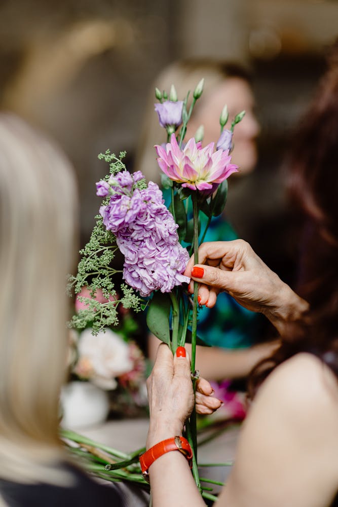 a close up of a person holding a flower