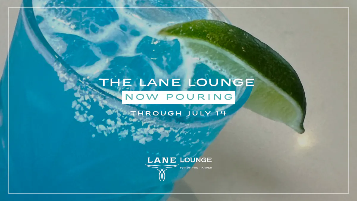 Close-up of a bright blue Lane Lounge cocktail with lime and salted rim.