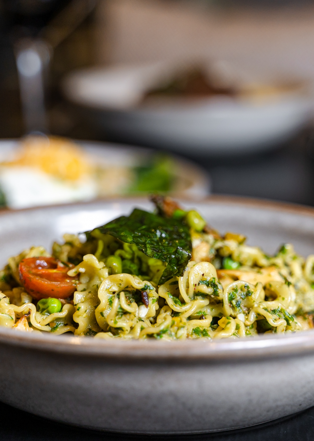 a bowl of pasta with vegetables and meat