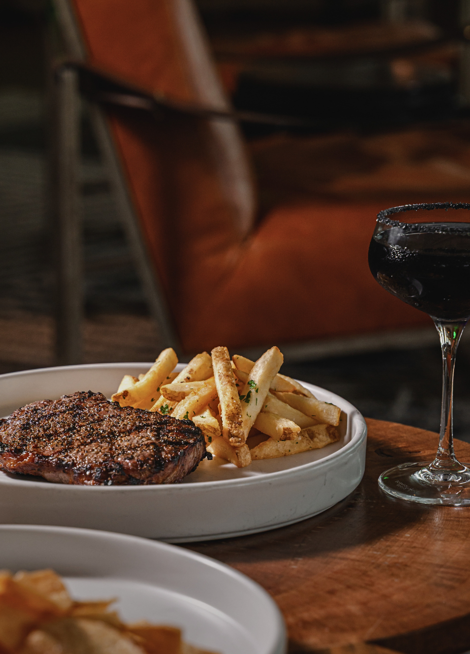 a plate of steak and fries on a table