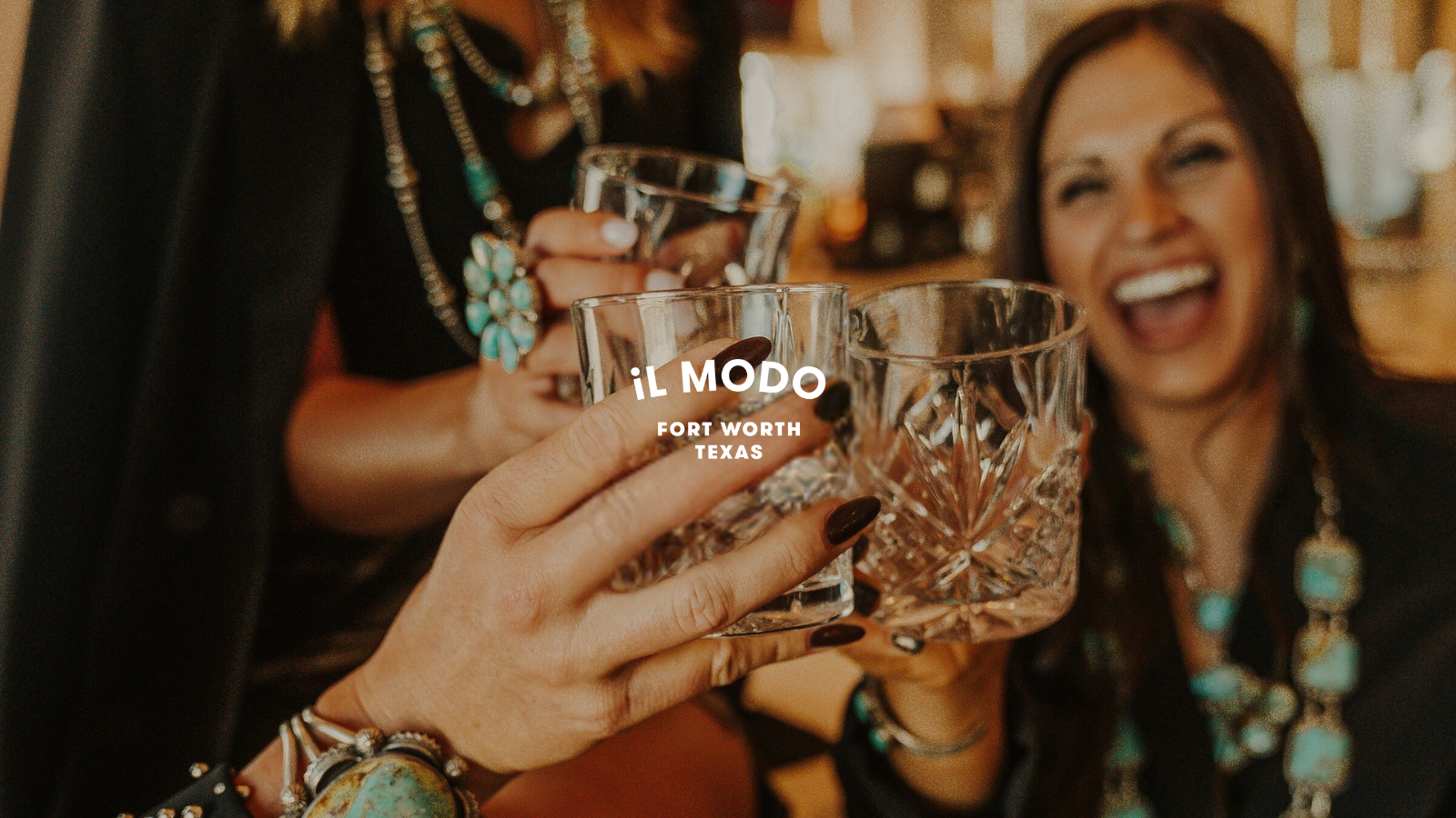 Friends clinking cocktails at il Modo.