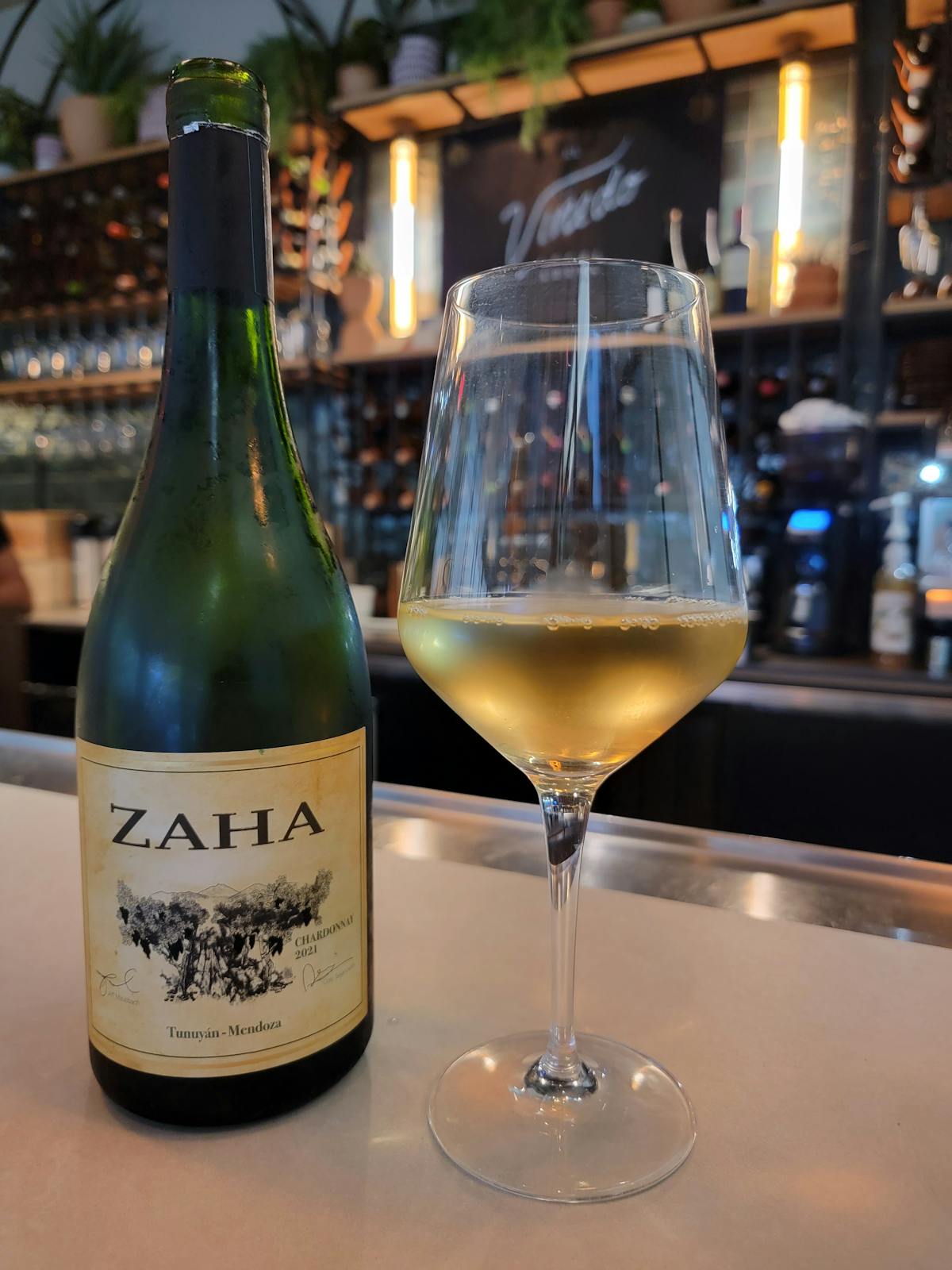 a close up of a bottle and a glass of wine