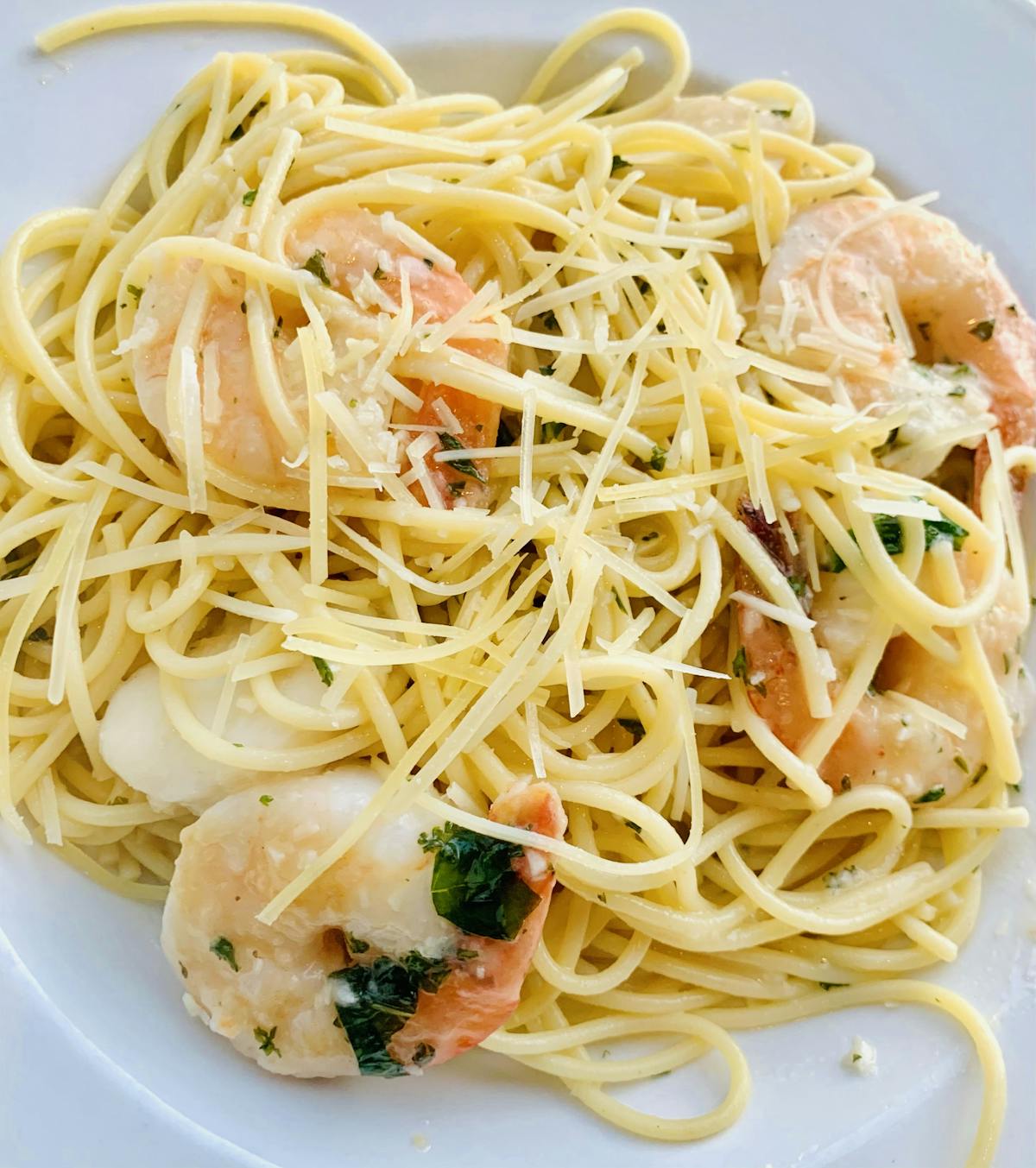 a close up of a plate of pasta with sauce and cheese