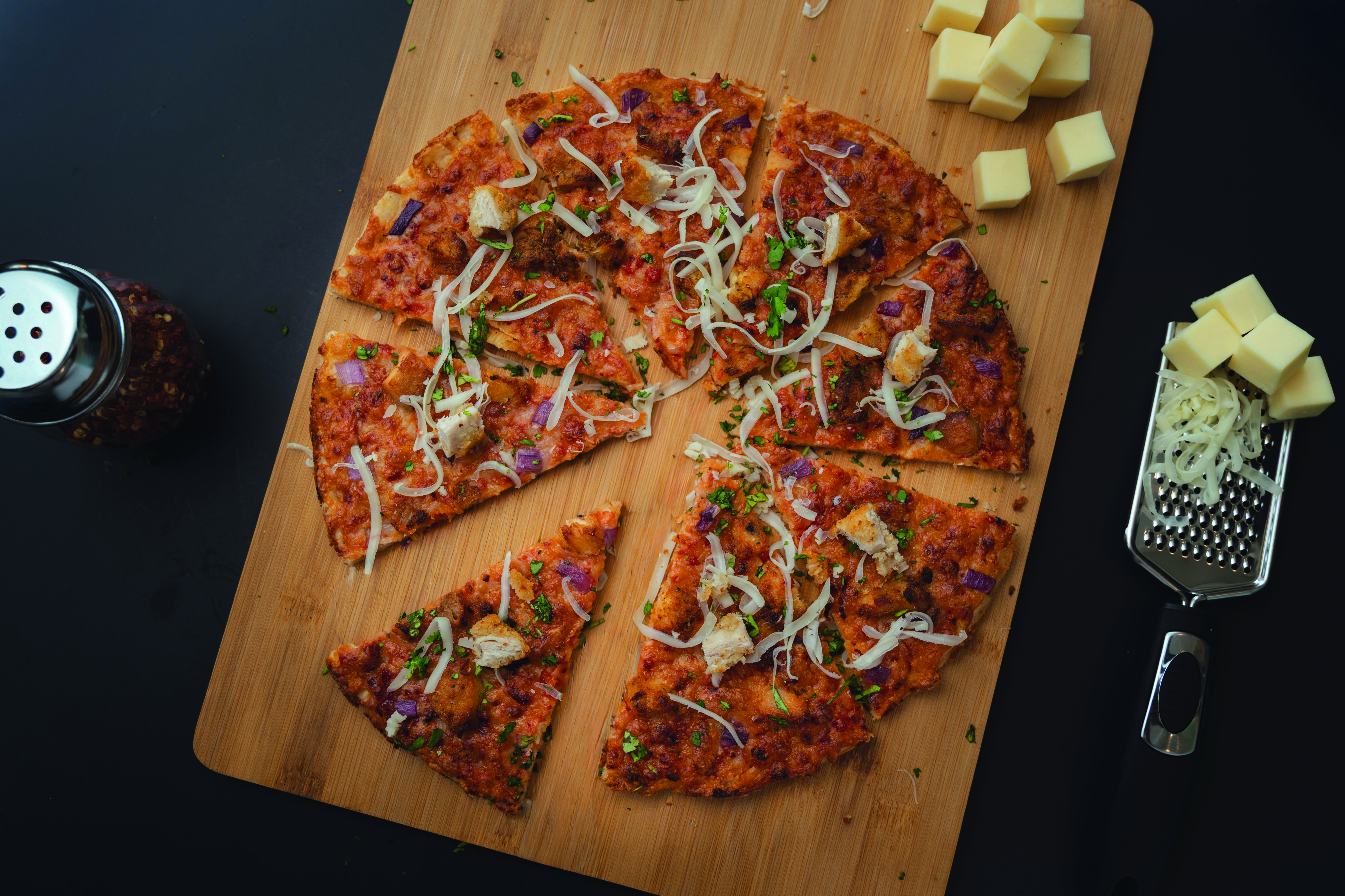 a pizza on a cutting board