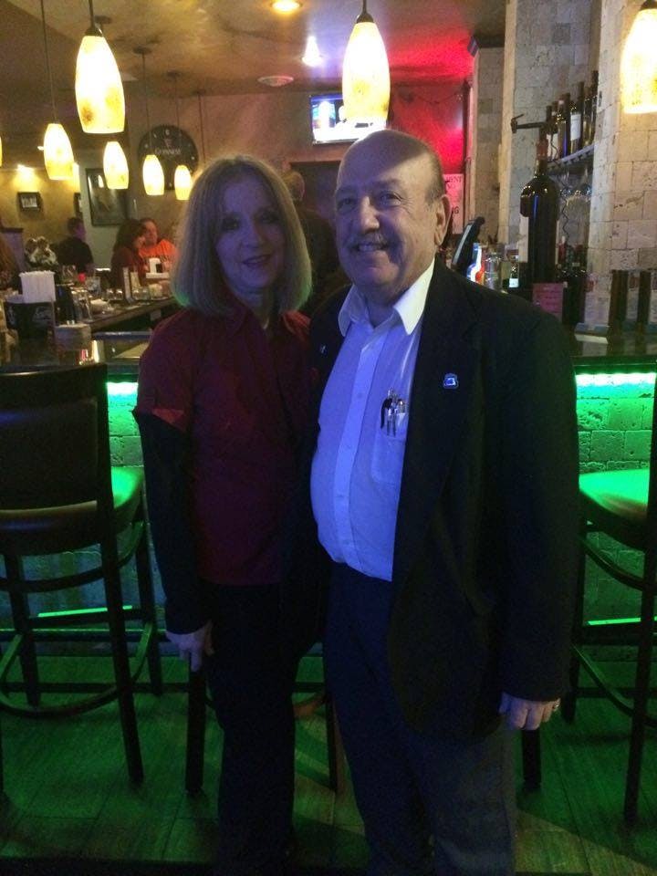 a man and a woman standing in front of a store