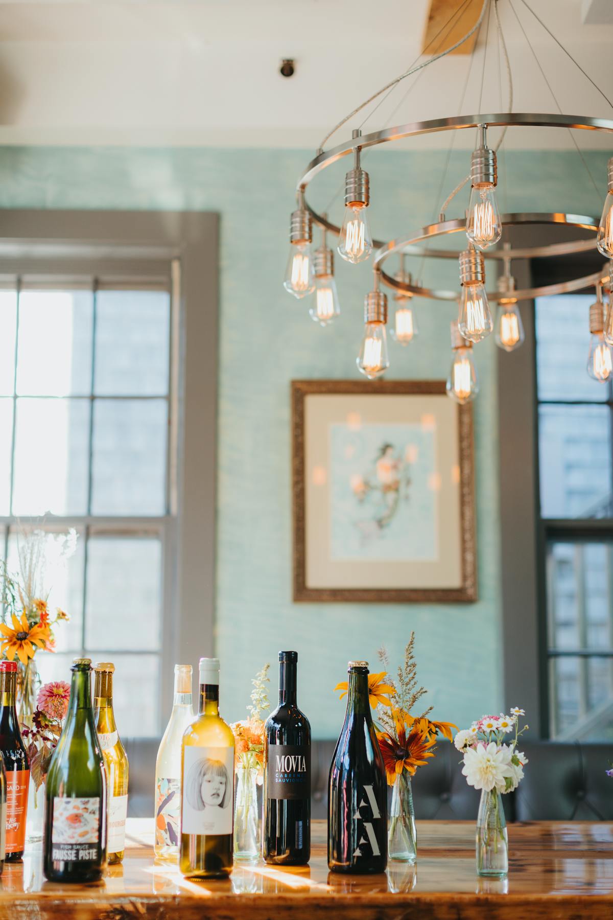 a vase of flowers on a table next to a window