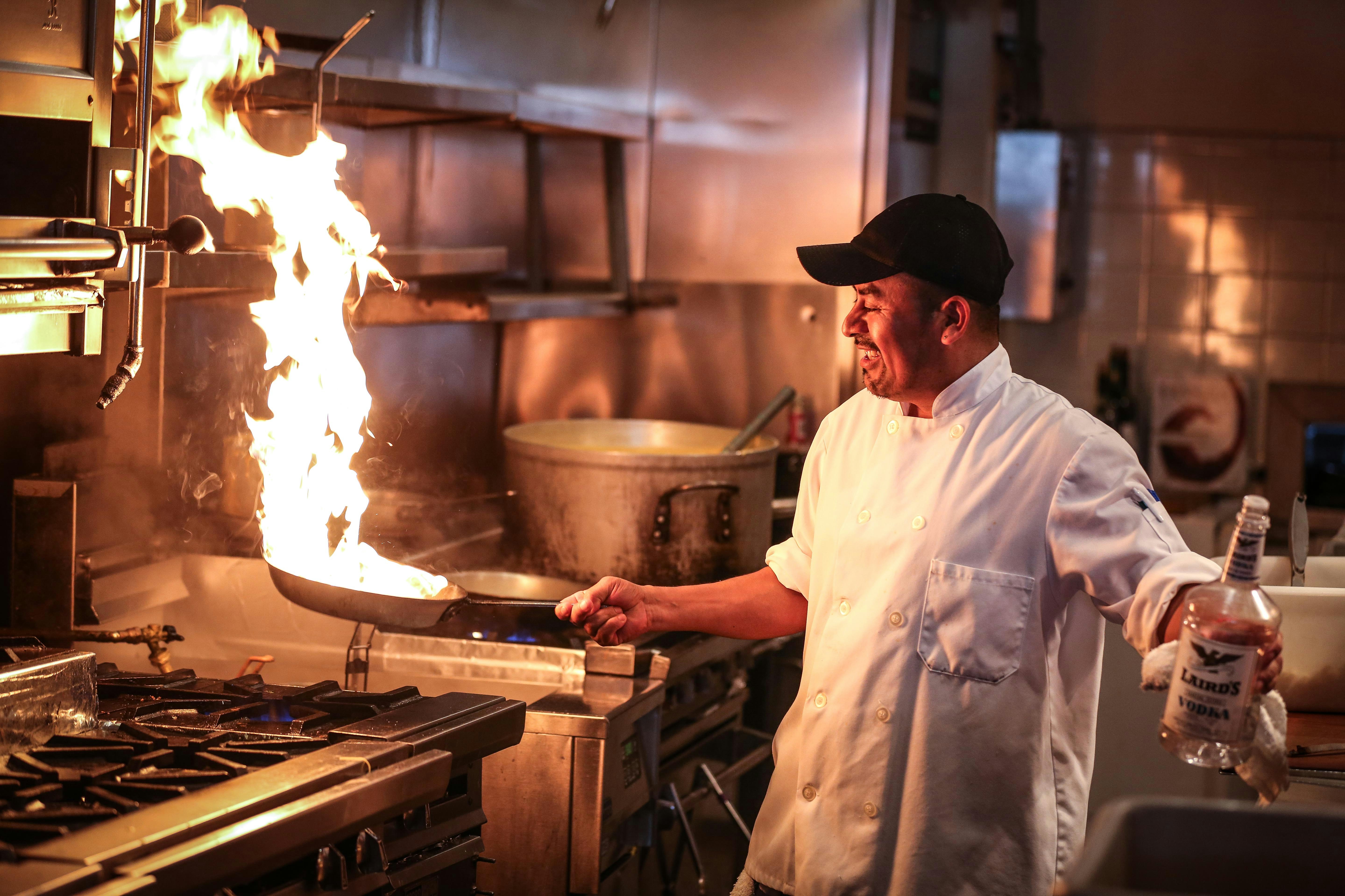 a man cooking in a kitchen preparing food
