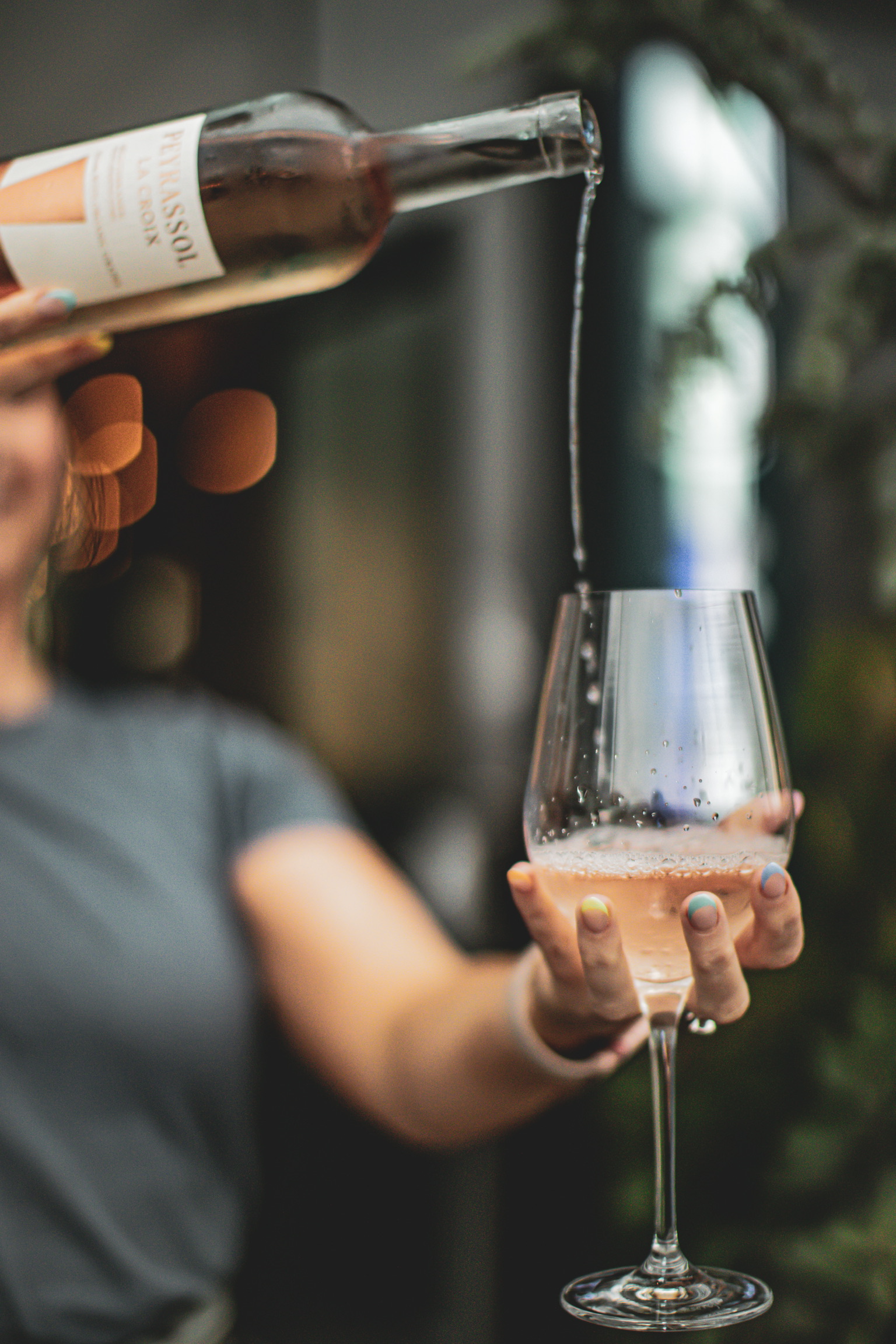 a hand holding a glass of wine