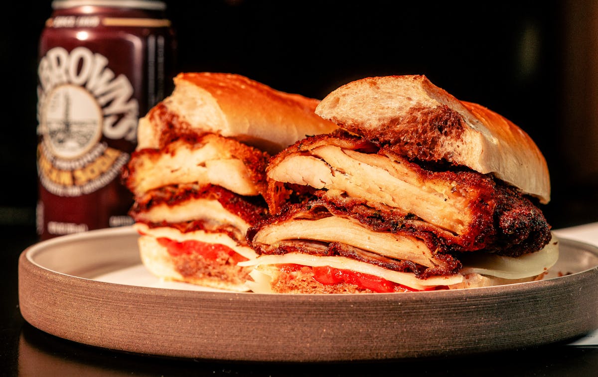 Triple stack sandwich served on a wooden plate