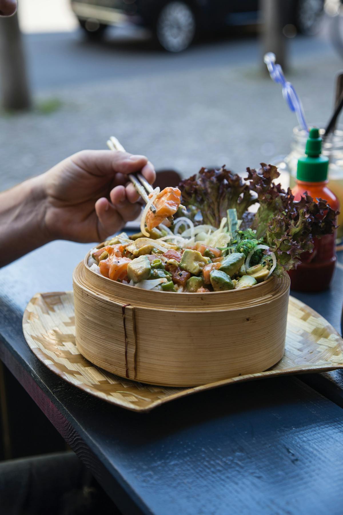 a person sitting at a table with a plate of food