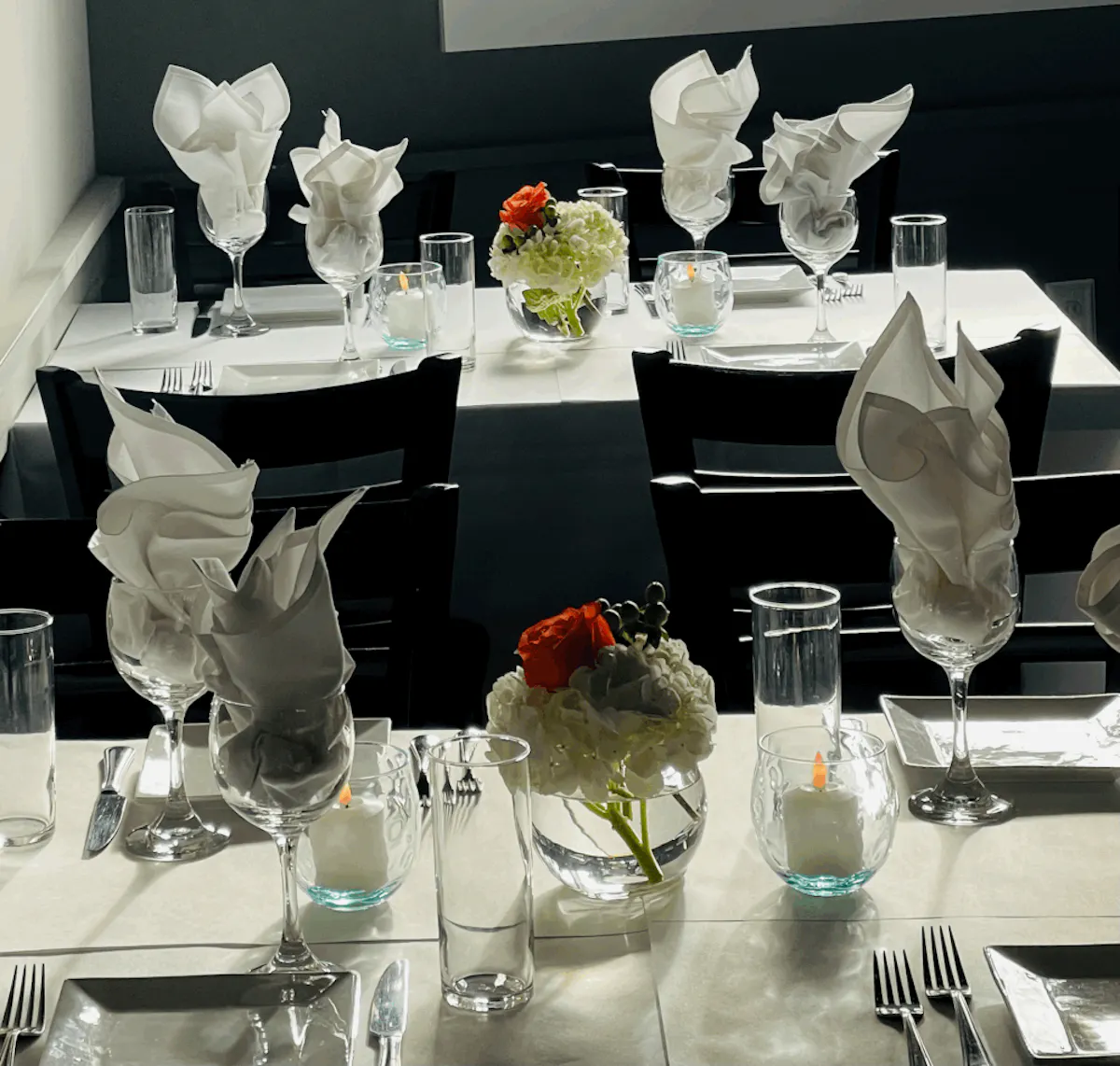 a group of people sitting at a table with wine glasses