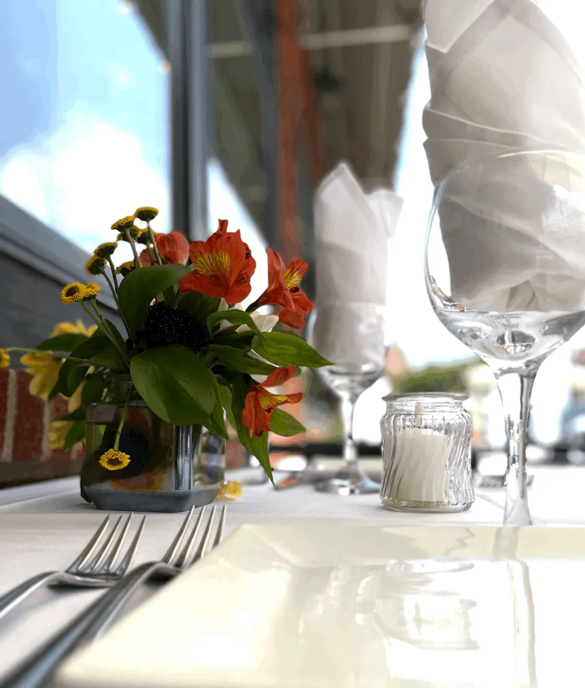 an empty plate with forks and glasses