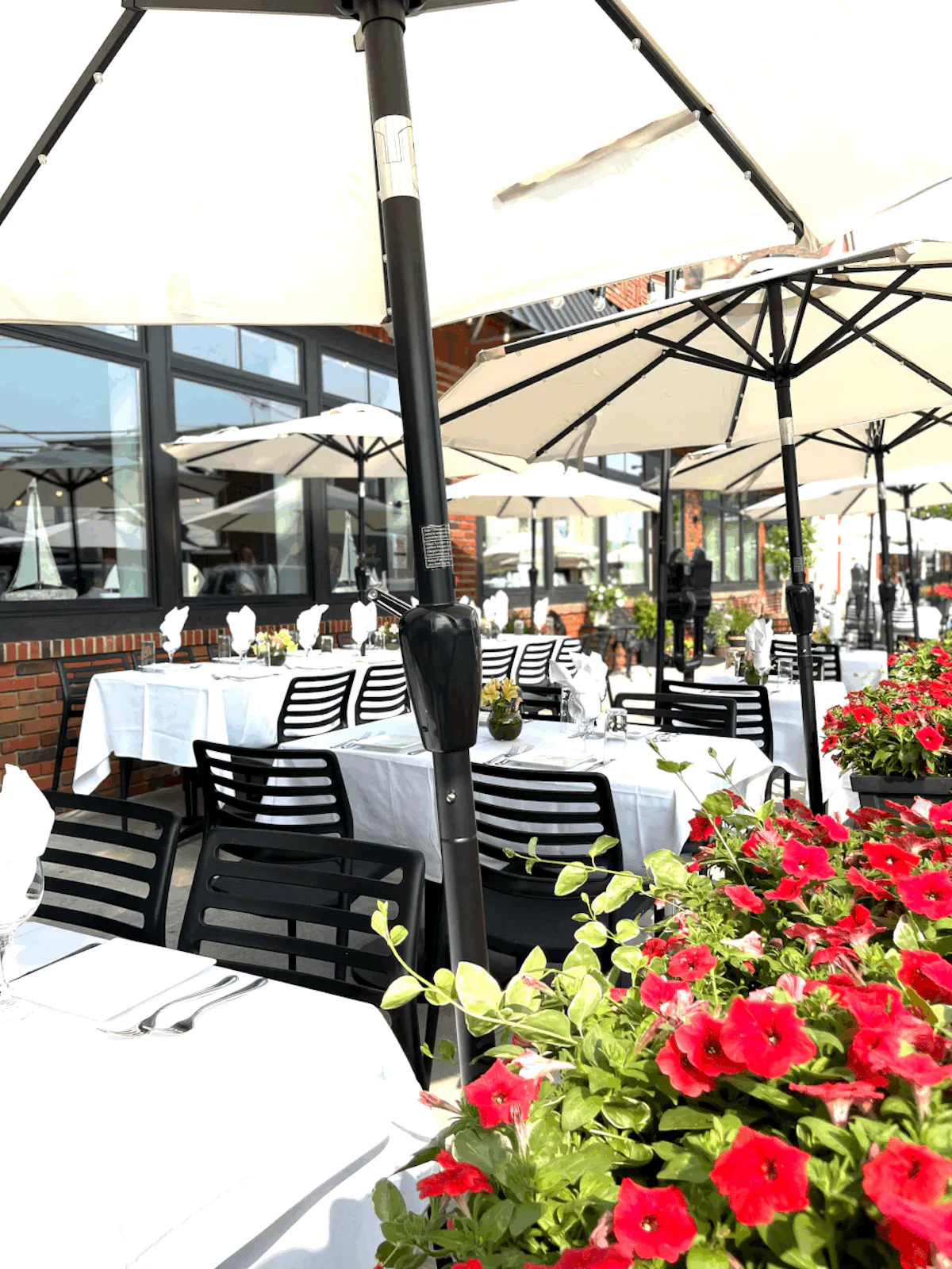 outdoors tables with chairs and umbrellas