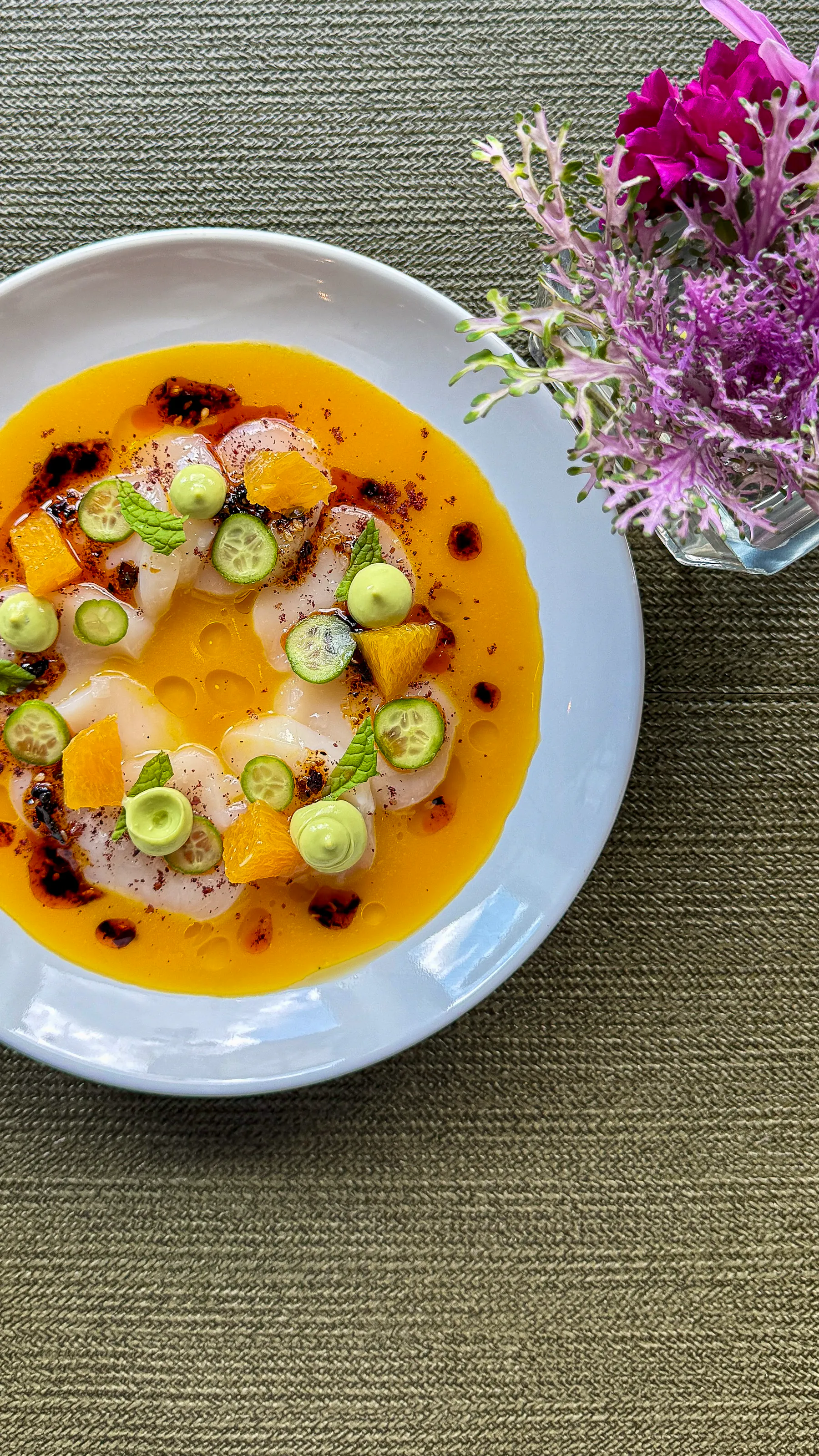 a plate of food with orange and vegetables