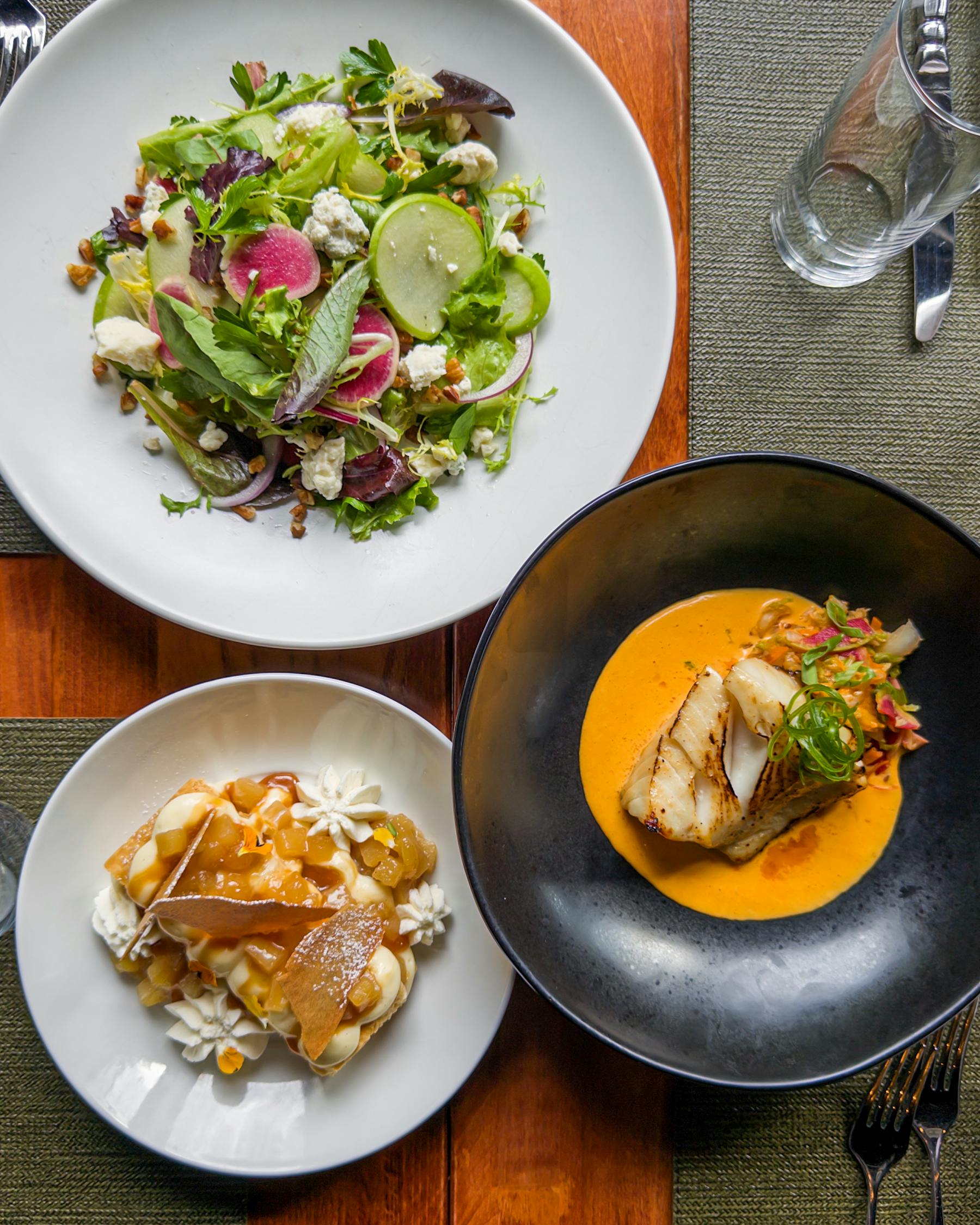 a bowl of food on a plate on a table