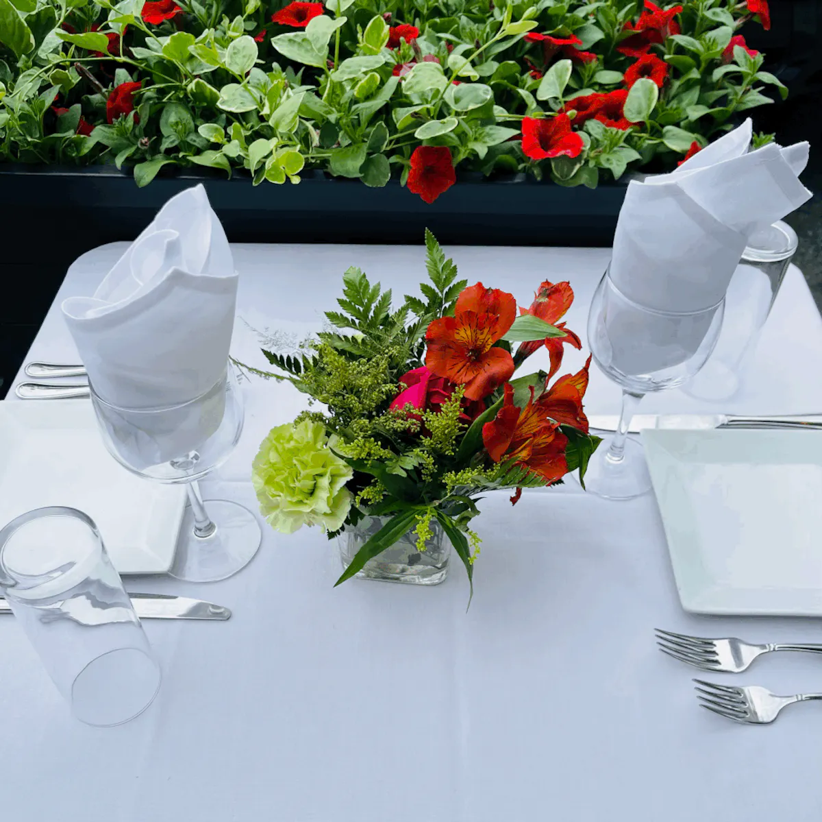 glasses and flowers over a table