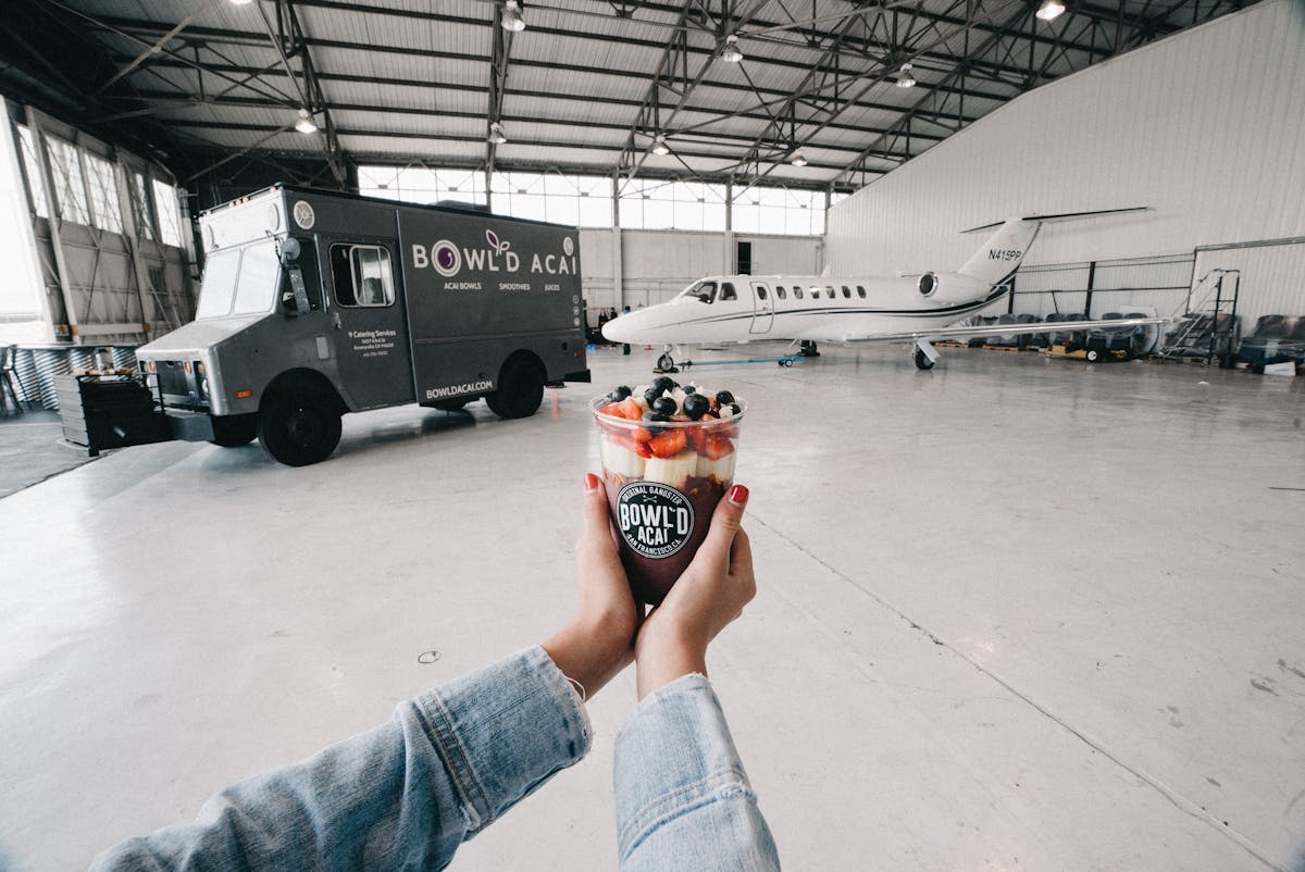 a hand holding an ice cream truck