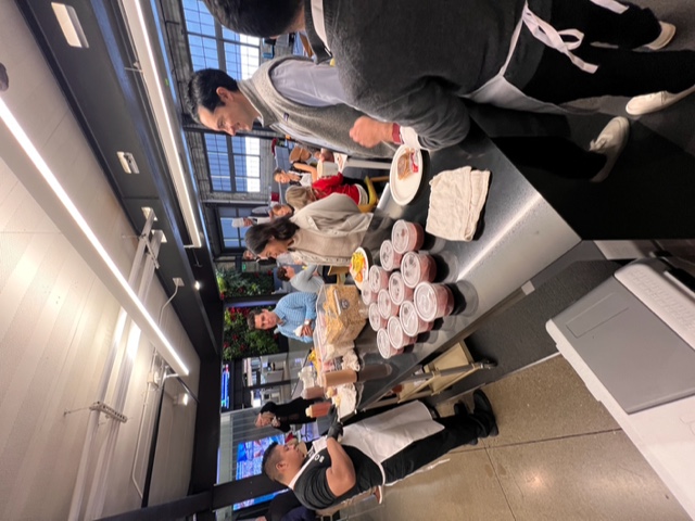 a group of people standing around a table