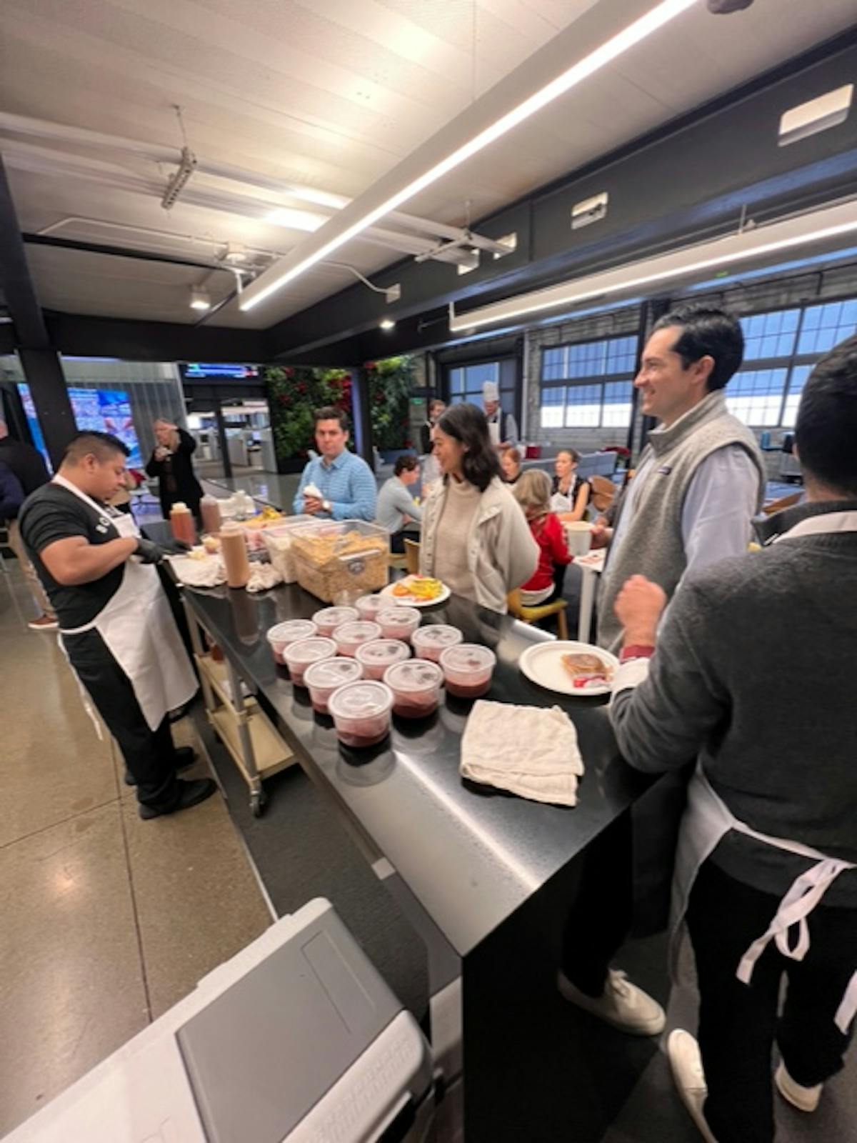a group of people standing around a table