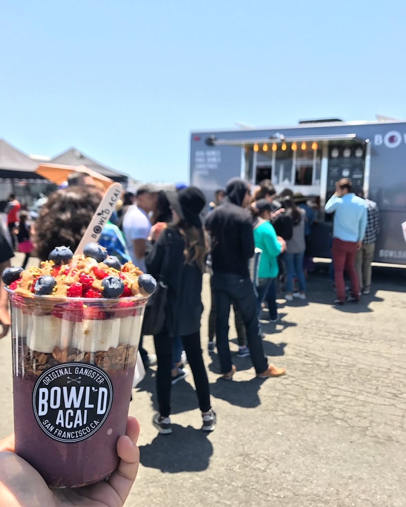 a person holding an acai cup