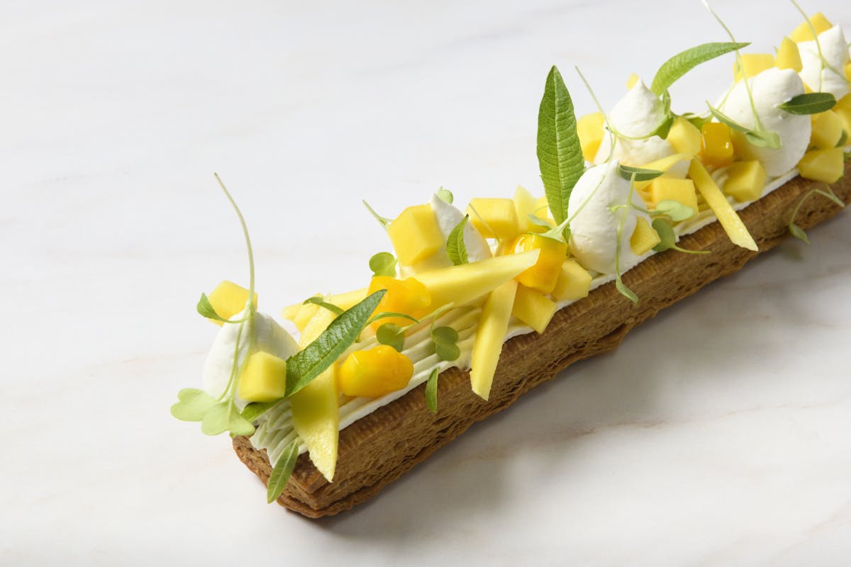 a plate of food with a slice of cake on a table
