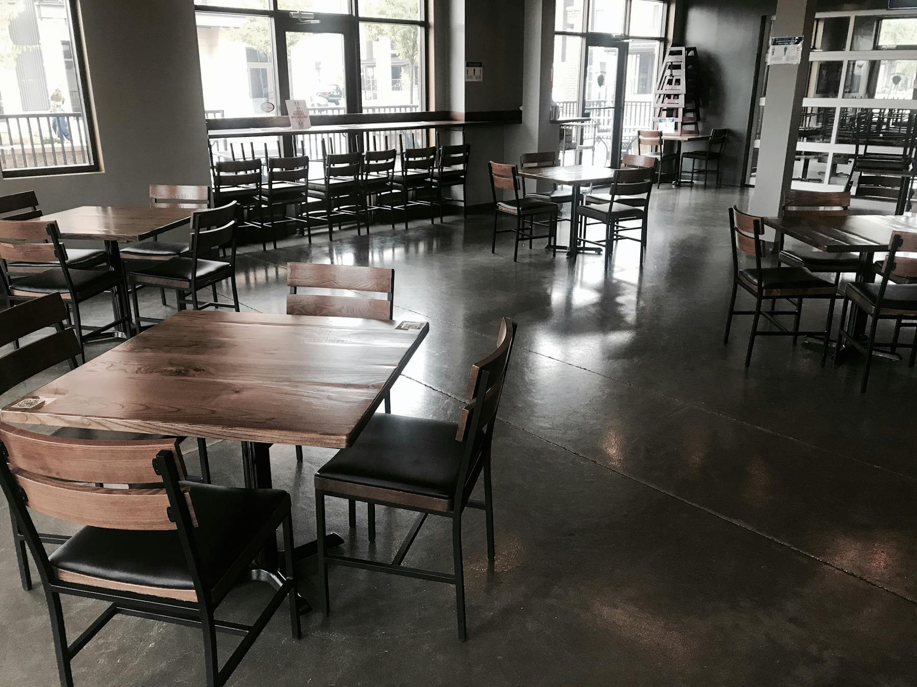 a dining room filled with furniture and a large window