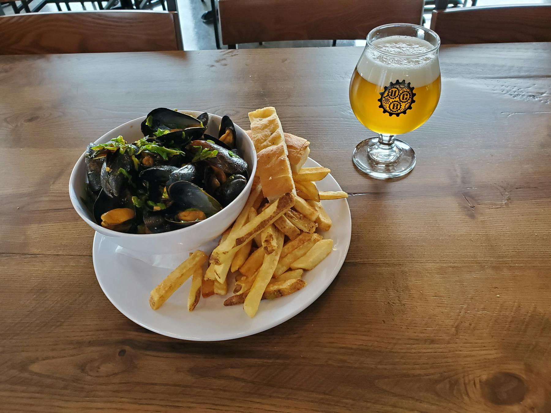 a plate of food and a glass of beer on a table