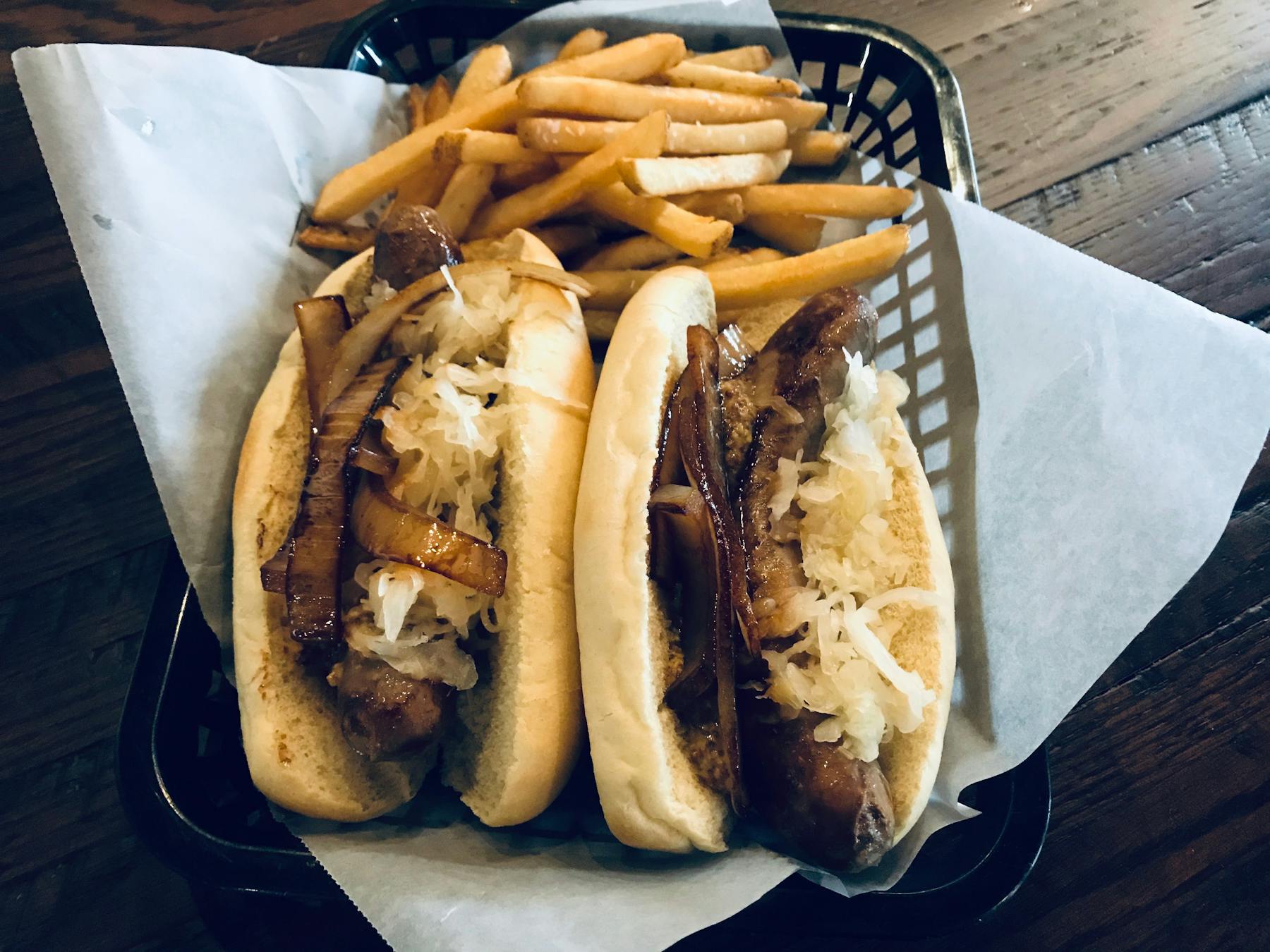 a basket of fries and a hot dog on a bun