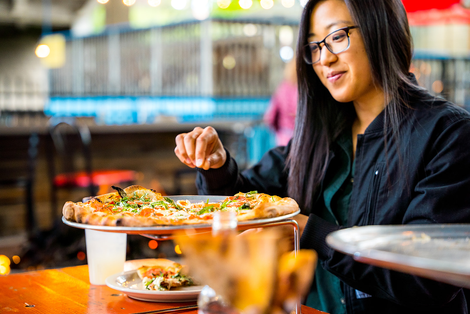 a woman sitting at a table with food