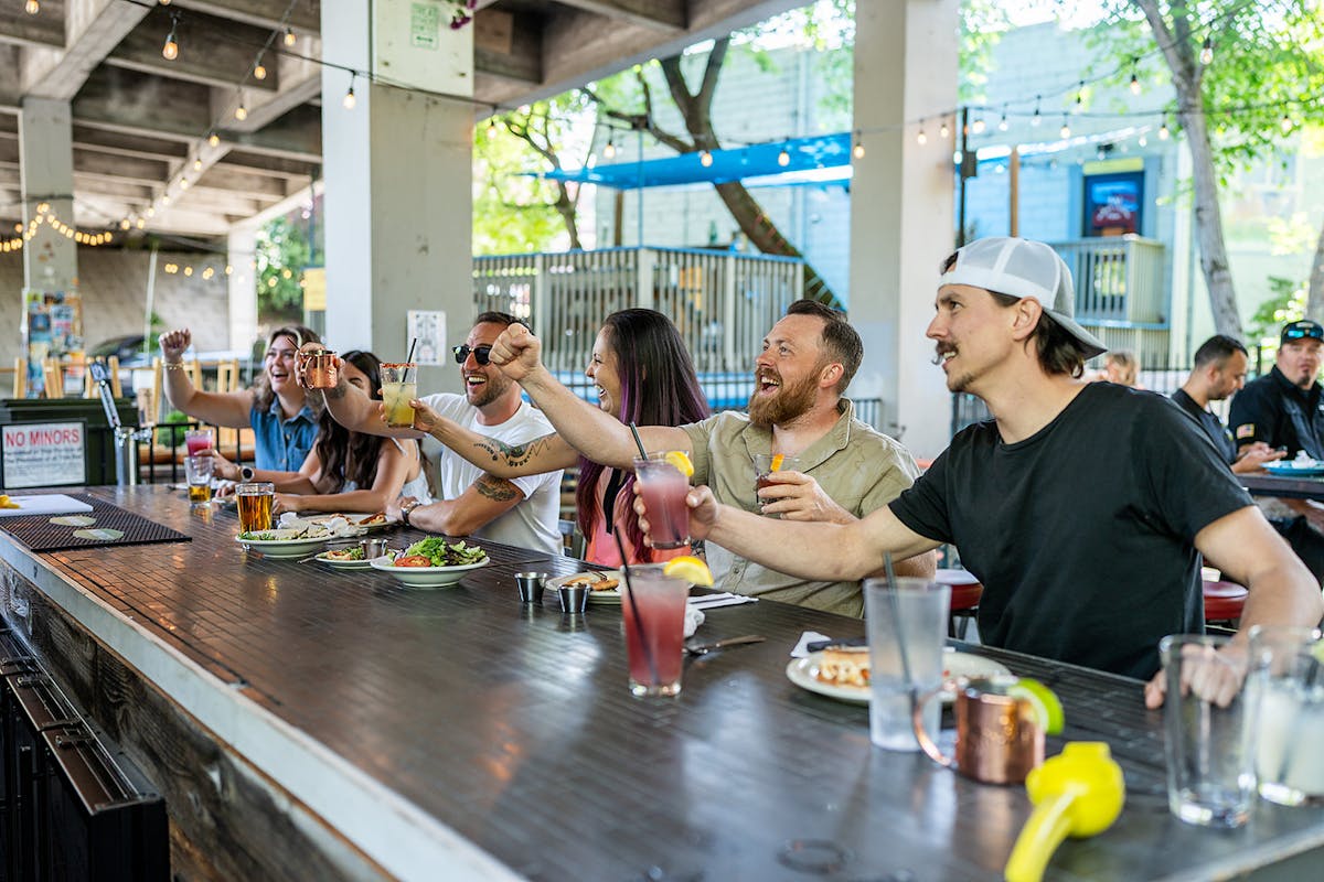 a group of people standing around a table