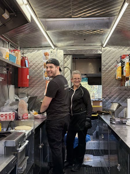a man standing in a kitchen preparing food