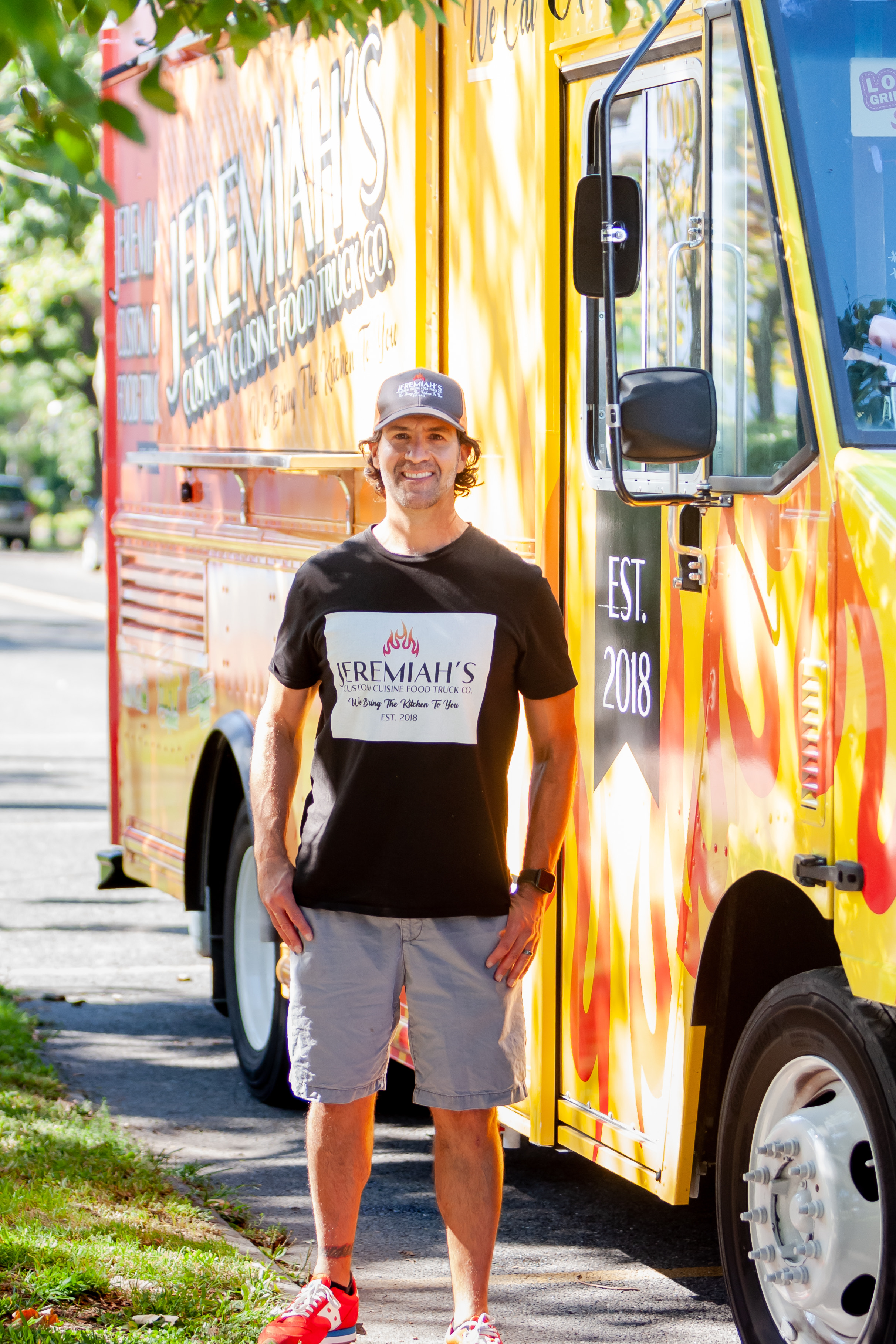 Eric Chavez standing in front of a bus