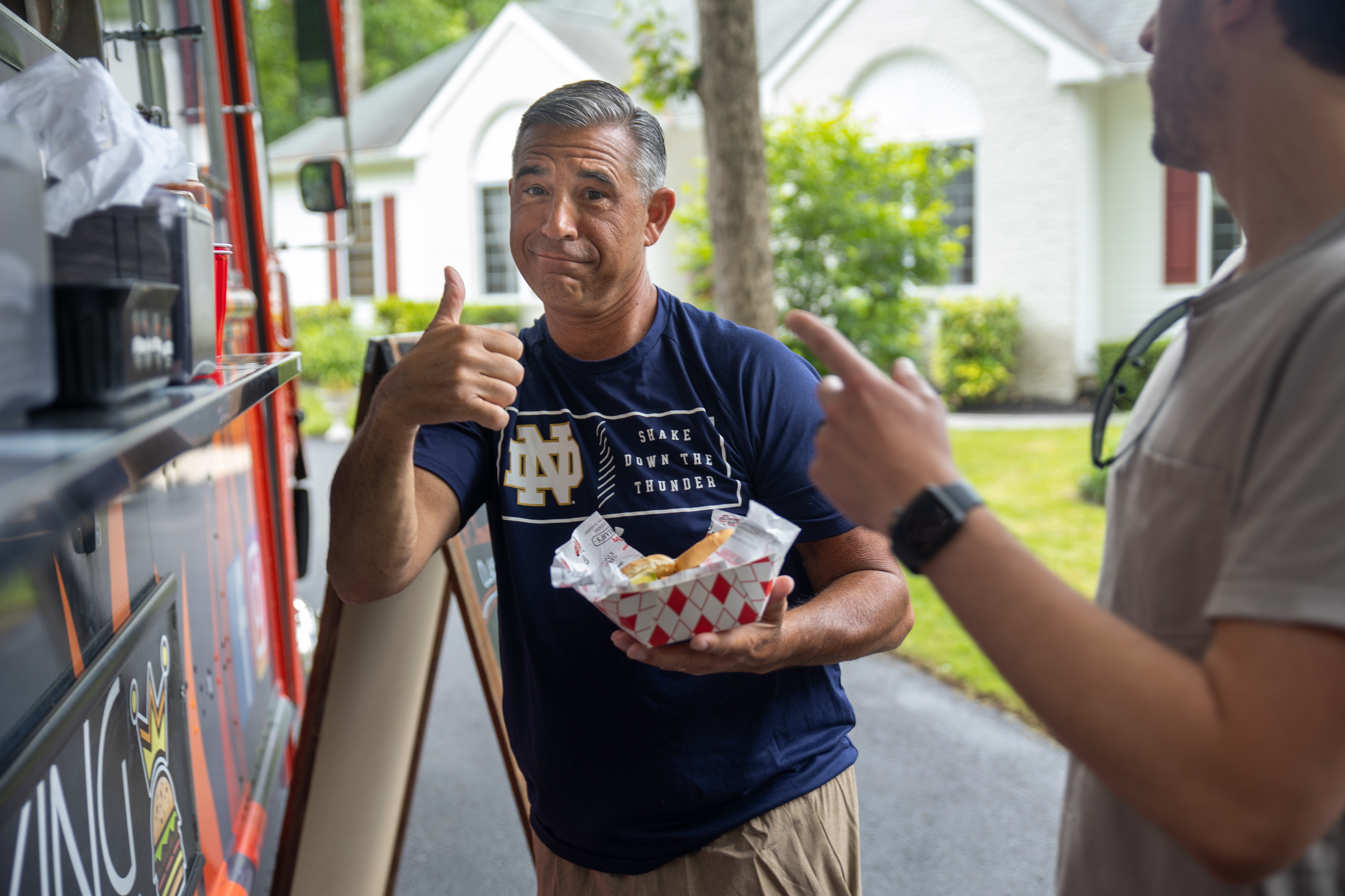a man holding a hot dog