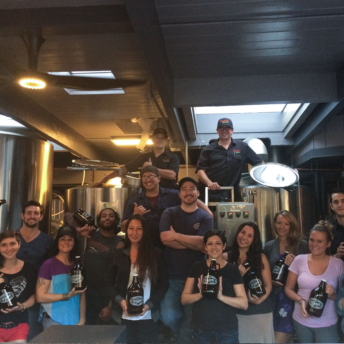 a group of people standing in front of a crowd posing for the camera