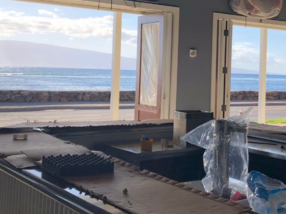 an island in the middle of a room next to a window