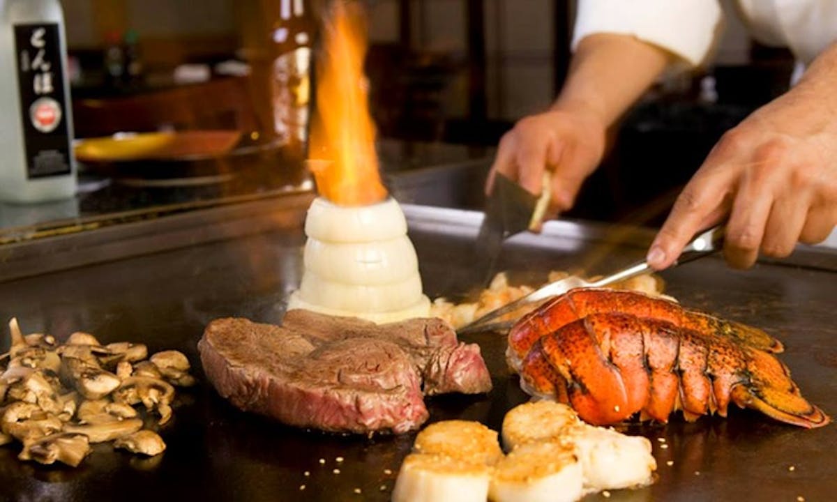 a person cutting food on a table