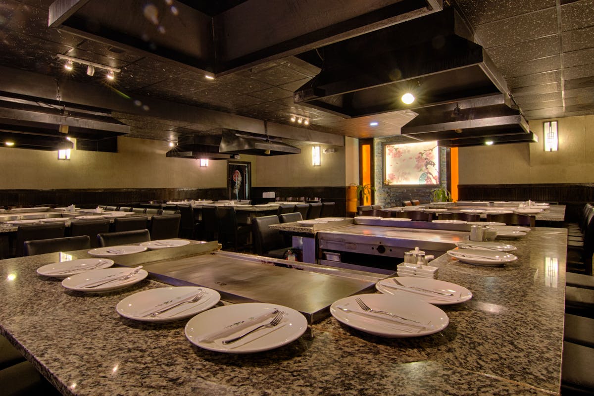 a large commercial kitchen with an island in the middle of a table