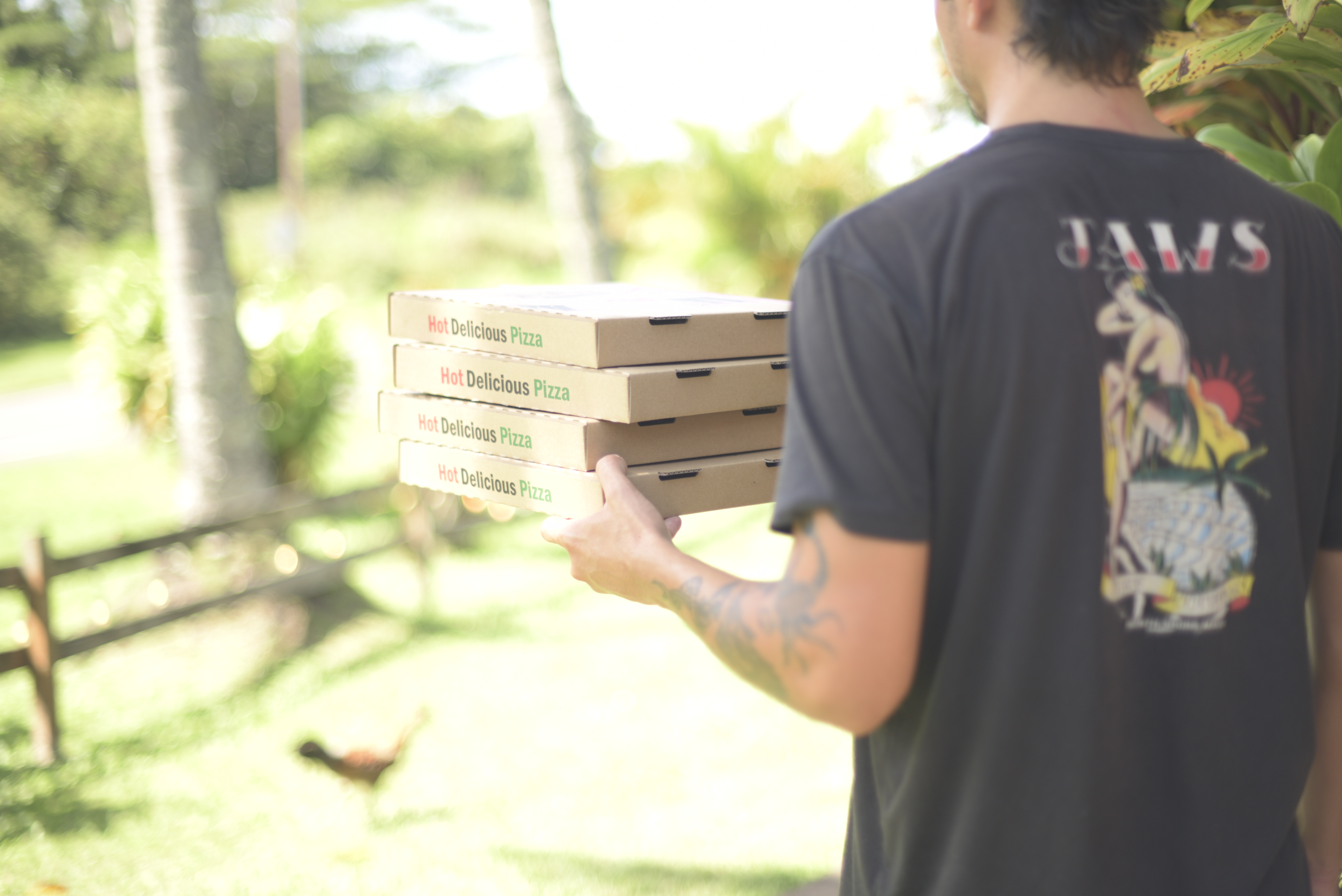 a man carrying pizza boxes