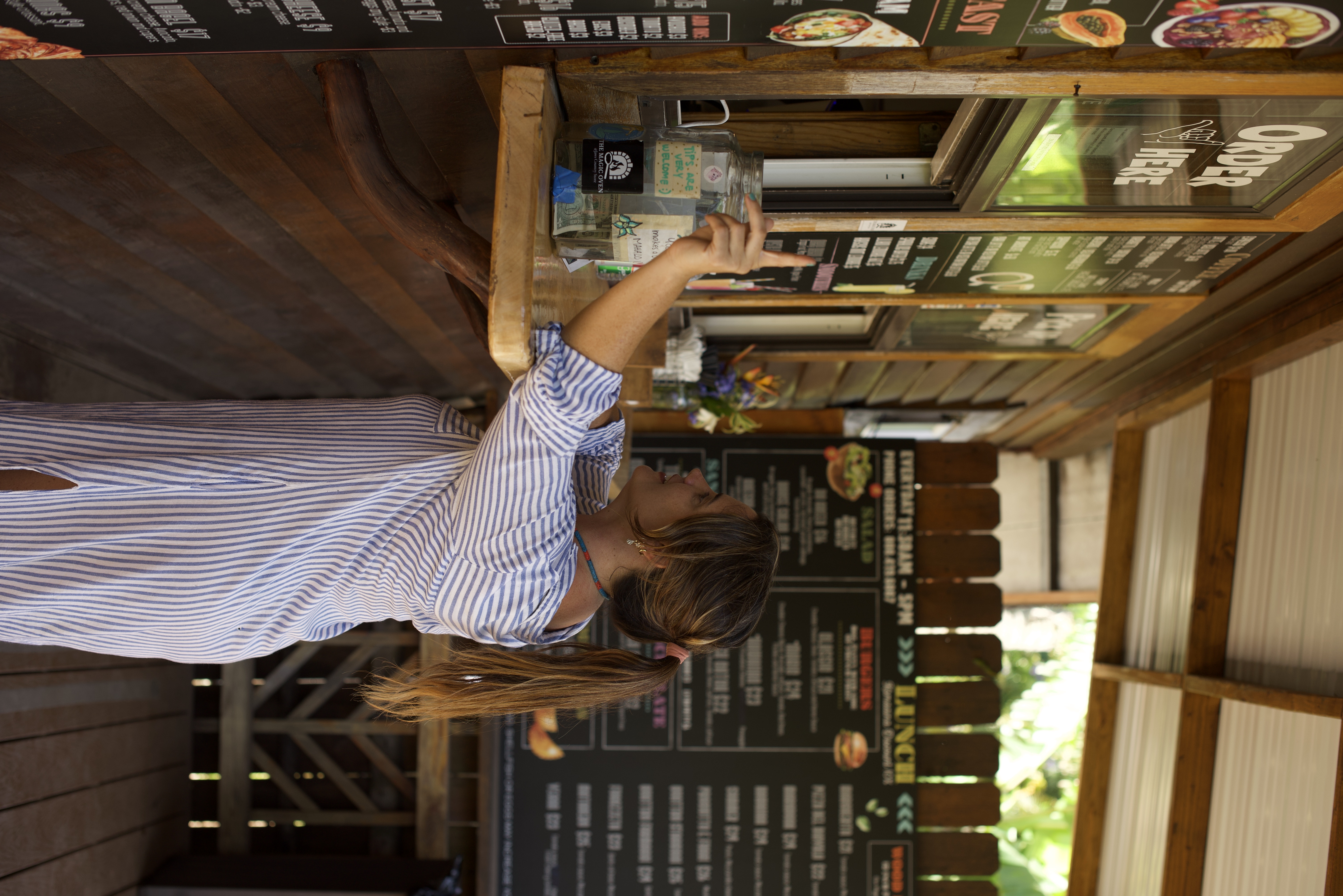 a woman pointing at a drink