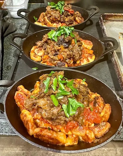 a pan filled with meat and vegetables