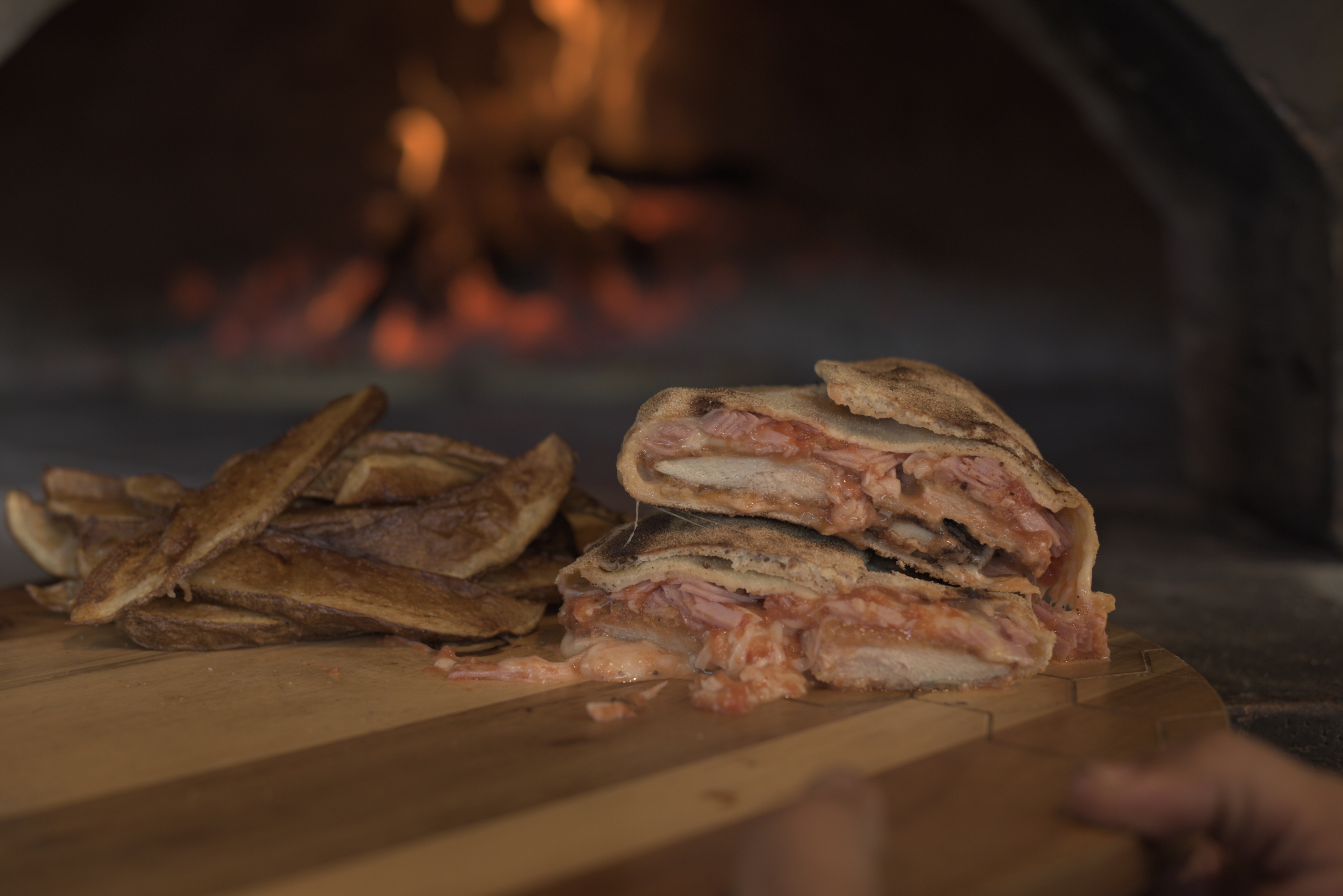 a sandwich cut in half on a wood surface
