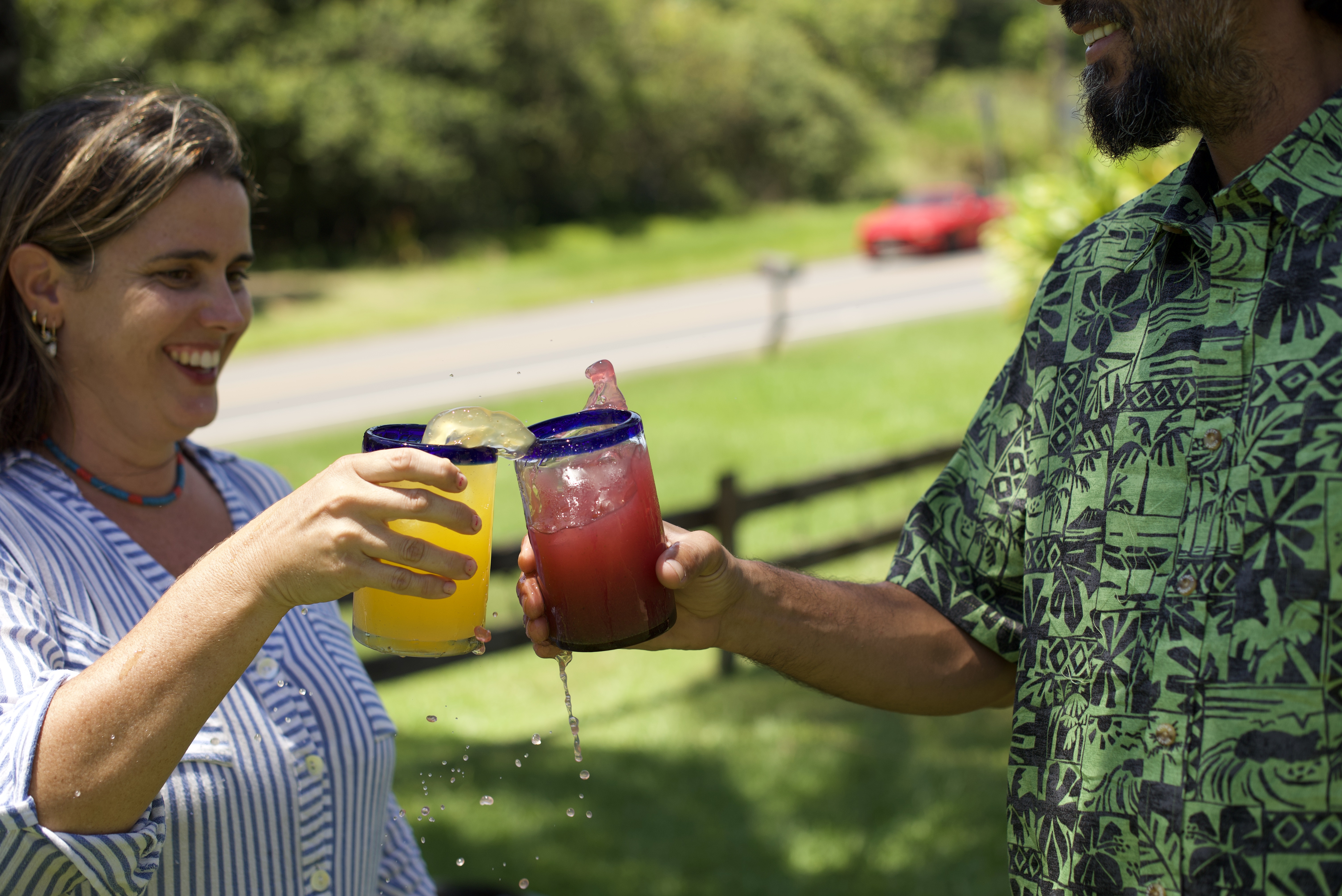 a man and woman holding drinks