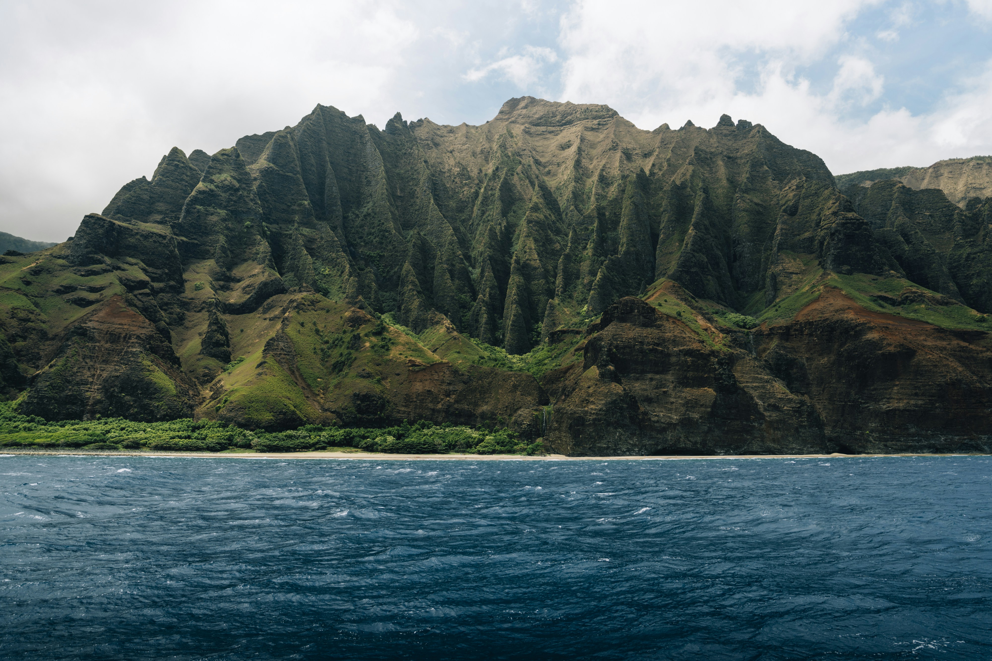 a large body of water with a mountain in the background